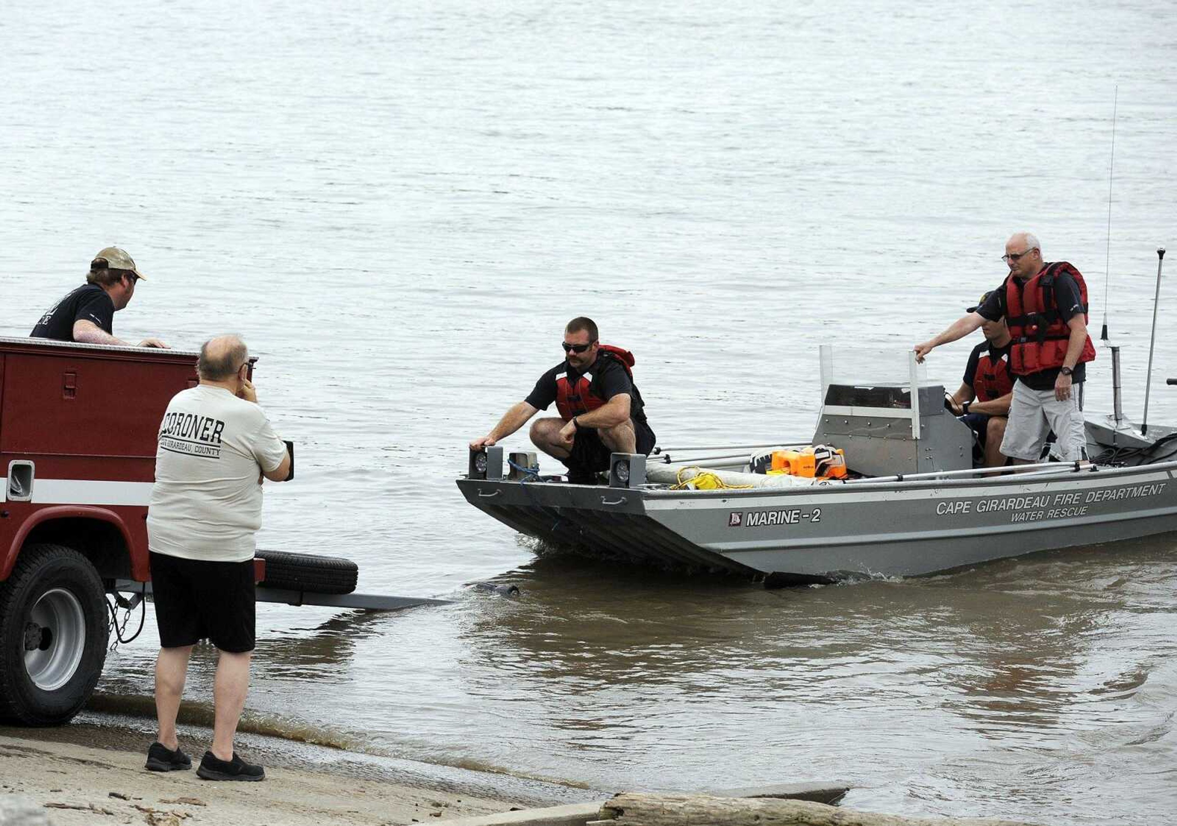 Cape Girardeau County Coronor John Clifton stands at the edge of the boat ramp as he waits for members of the Cape Girardeau Fire Department to dock at Red Star Access on Thursday afternoon. The fire and police departments recovered a body in the Mississippi River that was found just south of Missouri Dry Dock and Repair.