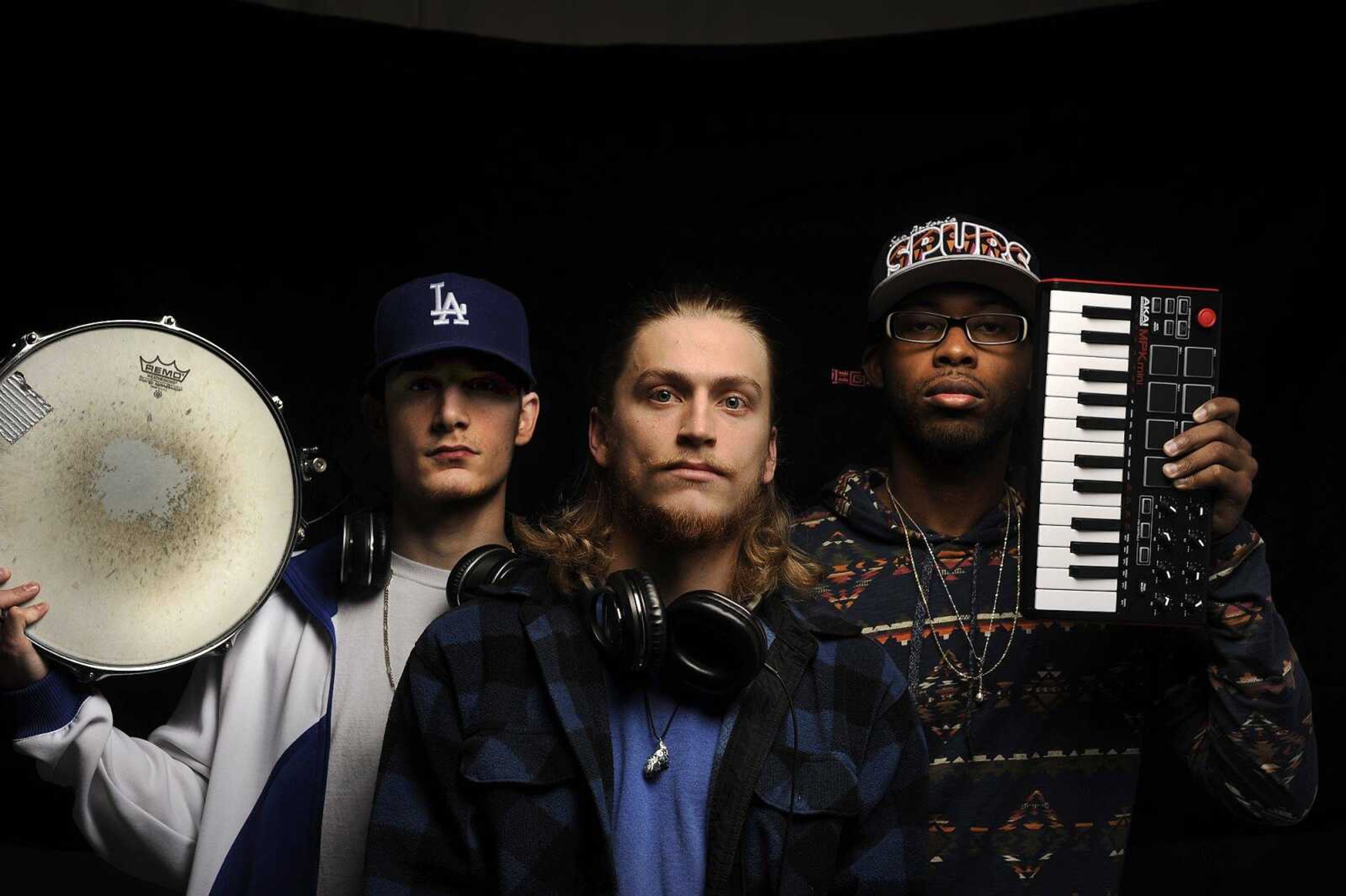 Nik "Niko Scarpy" Scarpaci, left, Angelo "Gelo" Wilson, center, and Amir "Amiricle" Waters of hip-hop group Imaginary Friends pose for a photo Wednesday.