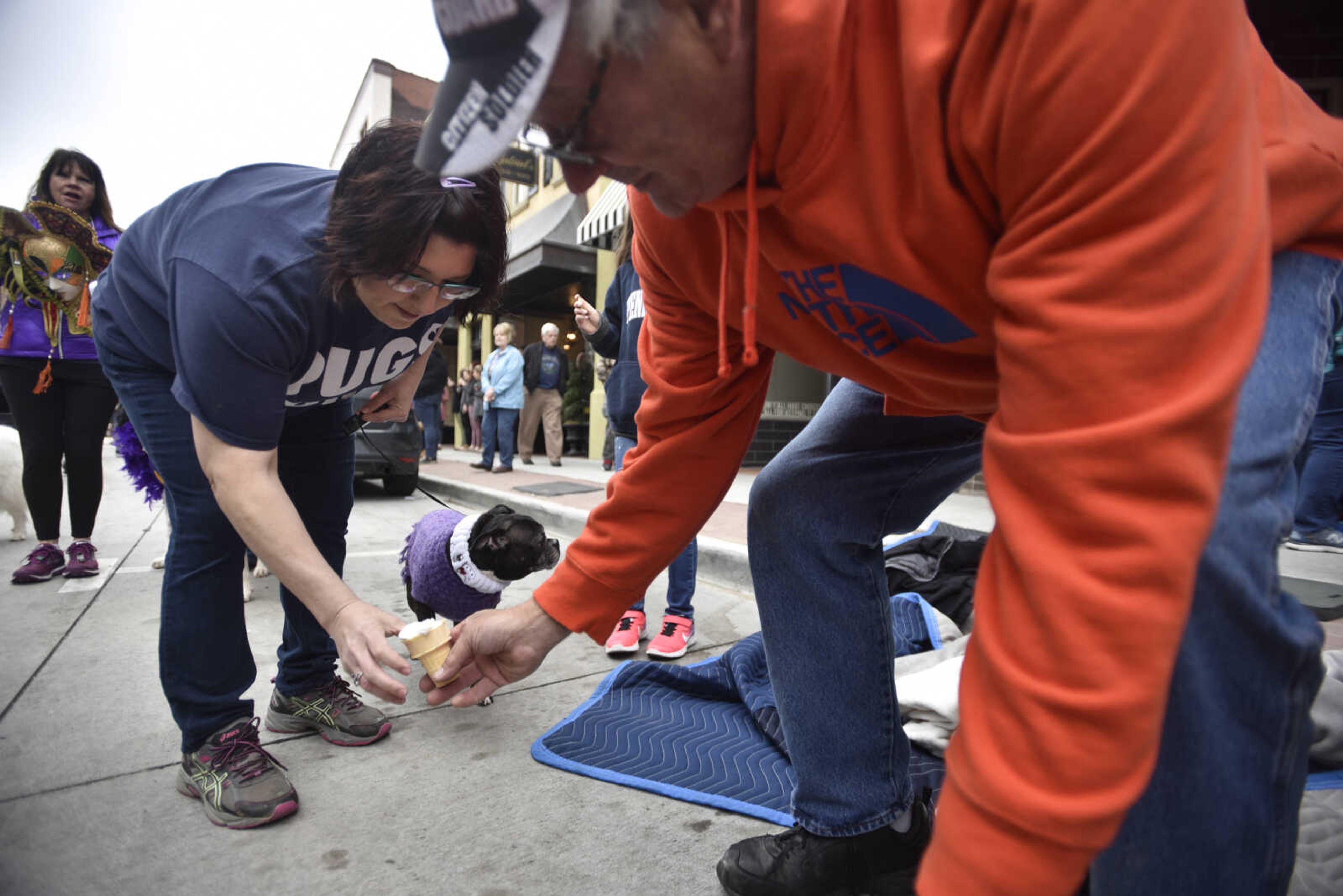 Christina Adams gets a whipped cream doggy cone for her dog, Dixie Belle, a "bug" mix, during the 2nd annual Mardi Paws Parade of Pets on Sunday, March 18, 2018, in Cape Girardeau.