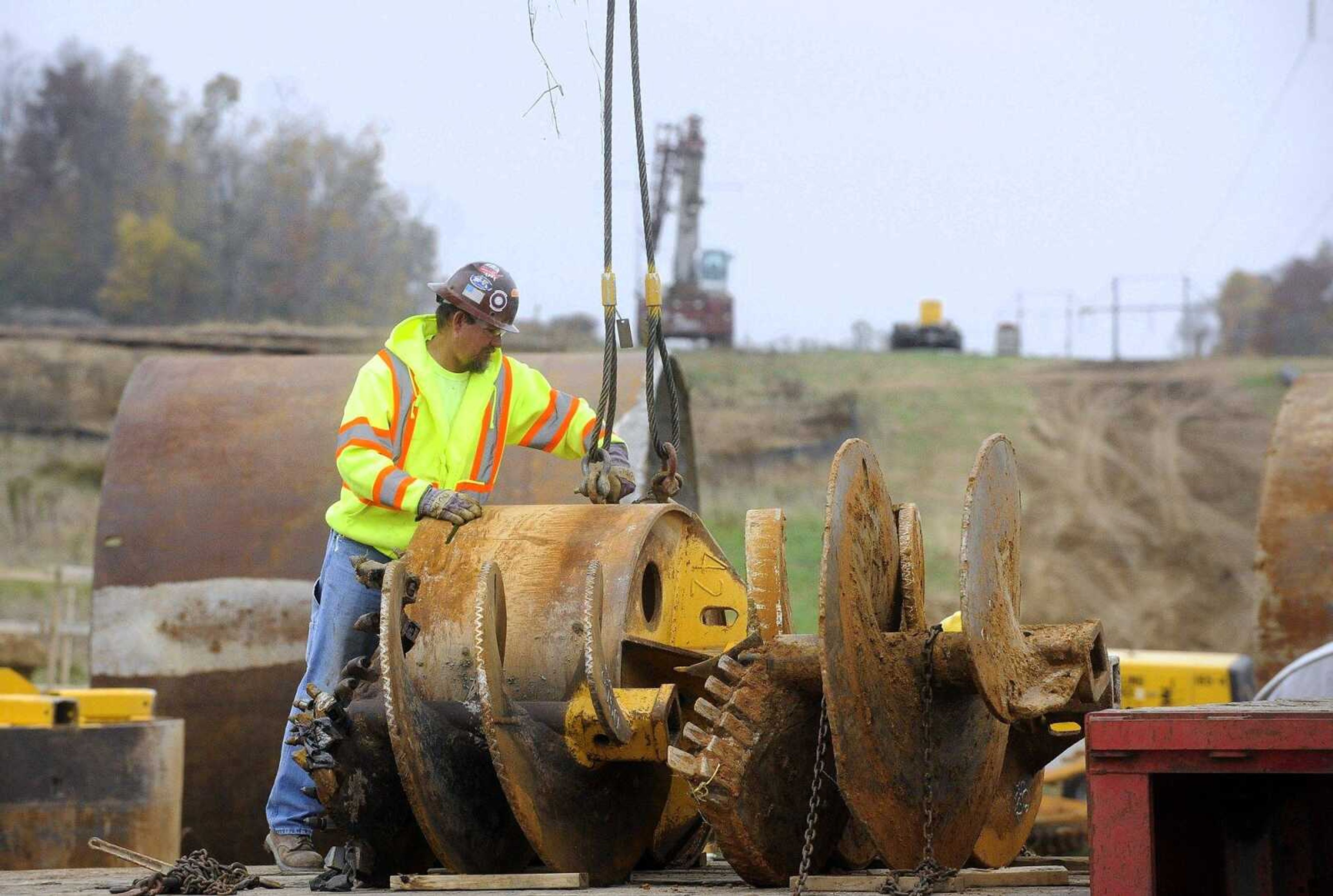 Workers load auger bits onto a flatbed after drilling out the placements in the ground Monday for a concrete foundation at the site of the new Ameren Missouri substation off Route K in Cape Girardeau County/ (Laura Simon)