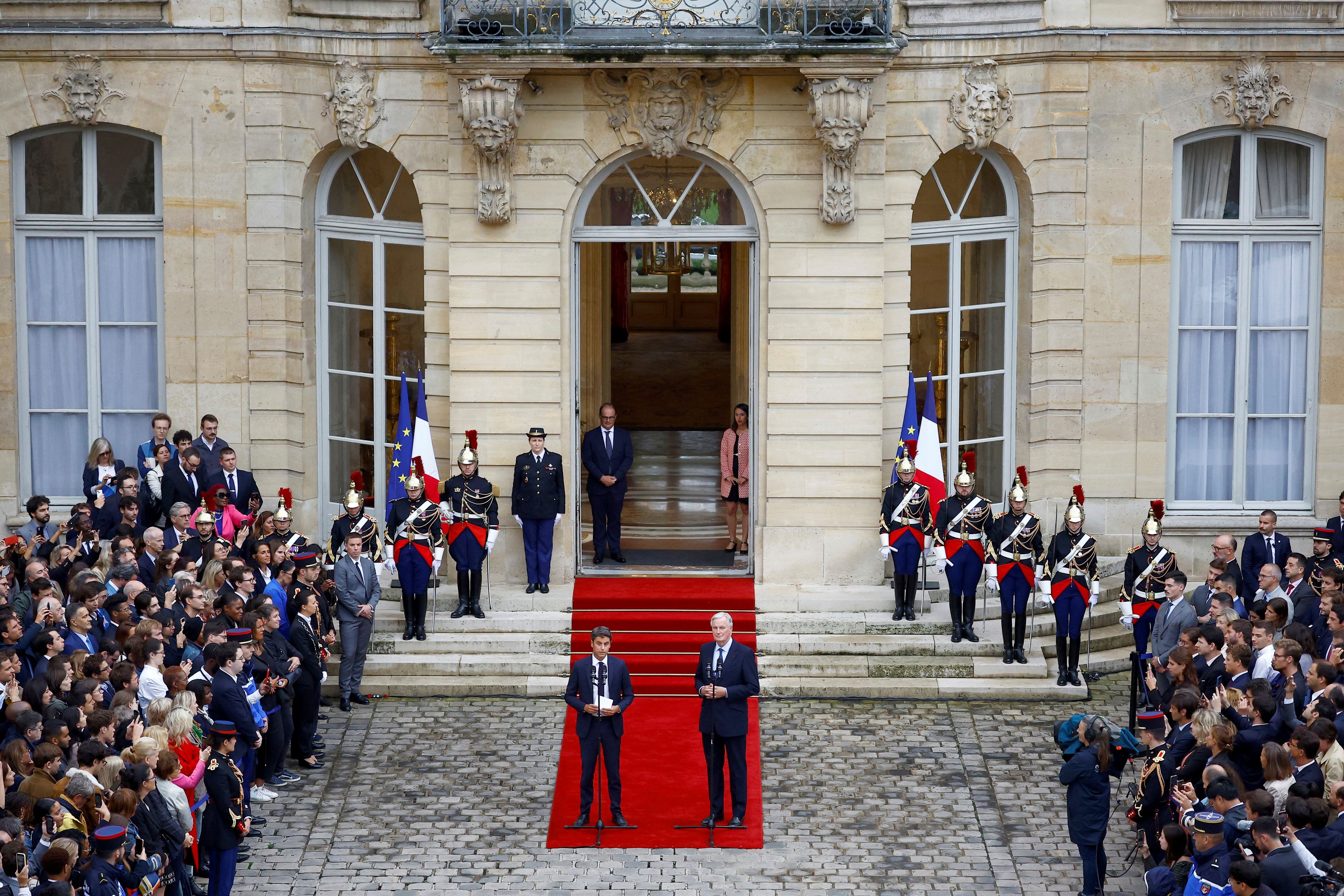 Outgoing French Prime Minister Gabriel Attal, center left, and new French prime minister Michel Barnier speak during the handover ceremony, Thursday, Sept. 5, 2024 in Paris. President Emmanuel Macron has named EU's Brexit negotiator Michel Barnier as France's new prime minister after more than 50 days of caretaker government. (Sarah Meyssonnier/Pool Photo via AP)