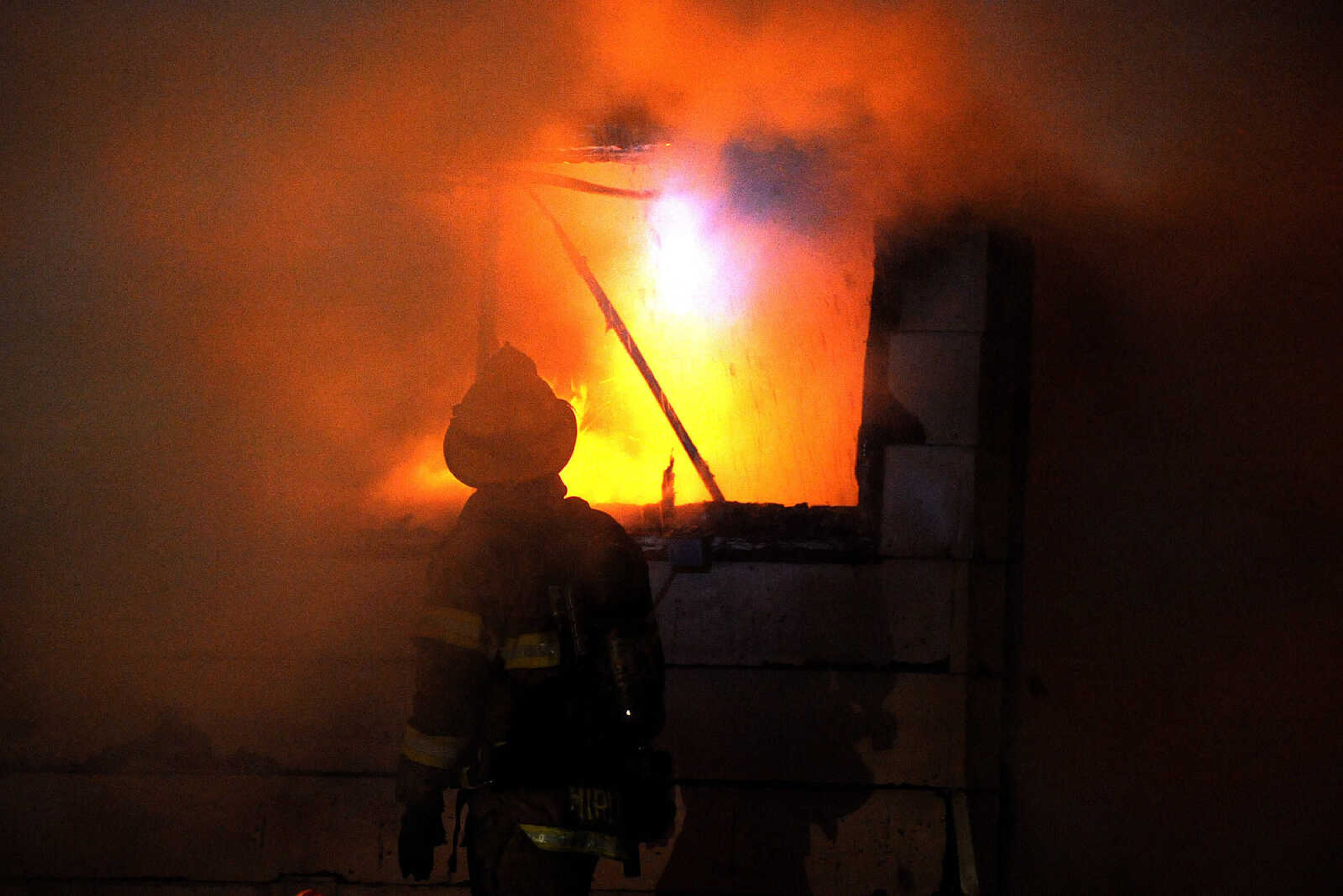 LAURA SIMON ~ lsimon@semissourian.com

Members of the Scott City and Cape Girardeau fire departments battle a blaze at 308 W. Missouri Blvd. in Scott City, Wednesday, Dec. 18, 2013. Nobody was injured in the fire.