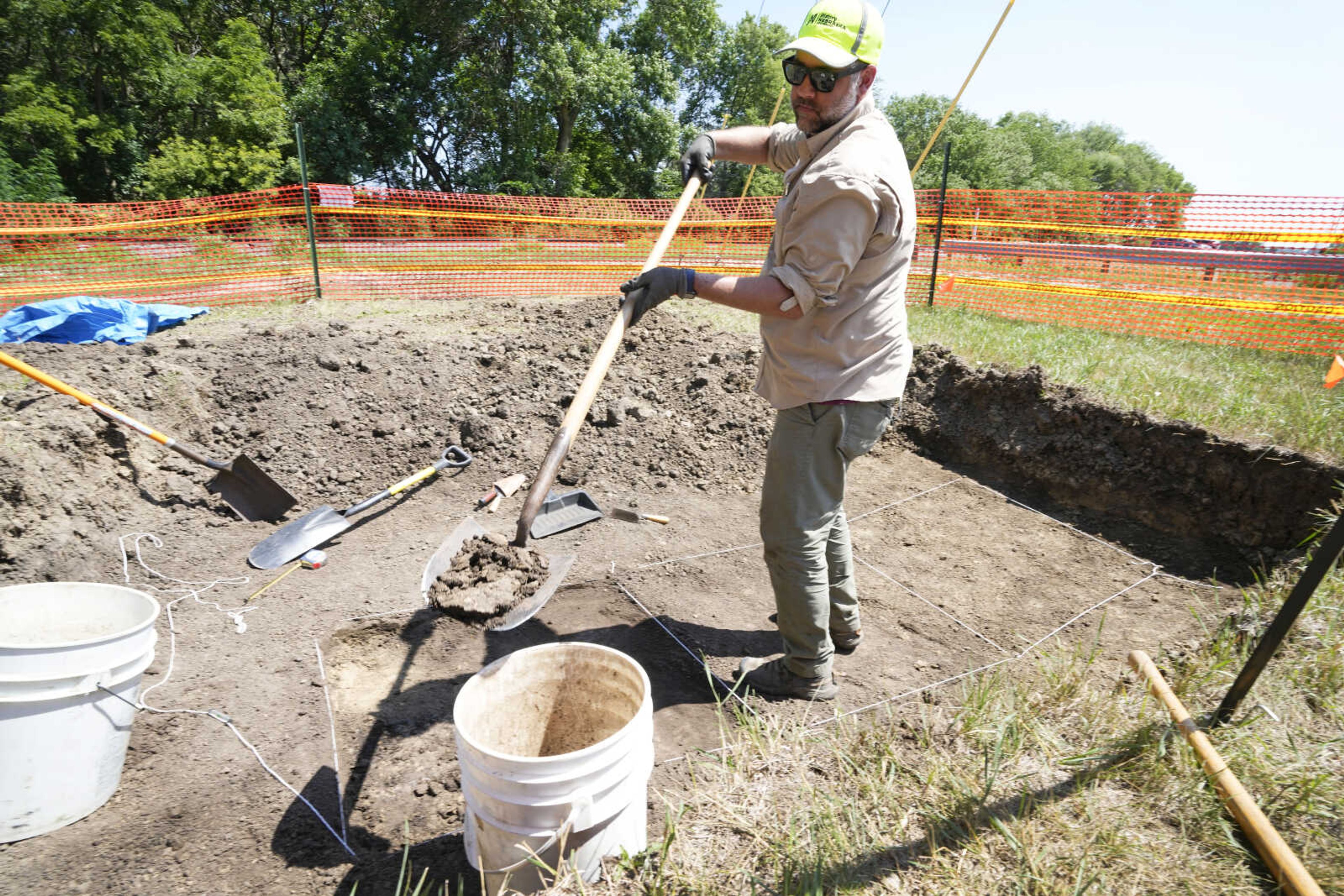 Nebraska state archeologist Dave Williams clears away soil Monday as workers dig for the suspected remains of children who once attended the Genoa Indian Industrial School in Genoa, Nebraska. The mystery of where the bodies of more than 80 children are buried could be solved this week as archeologists dig in a Nebraska field that a century ago was part of a sprawling Native American boarding school.