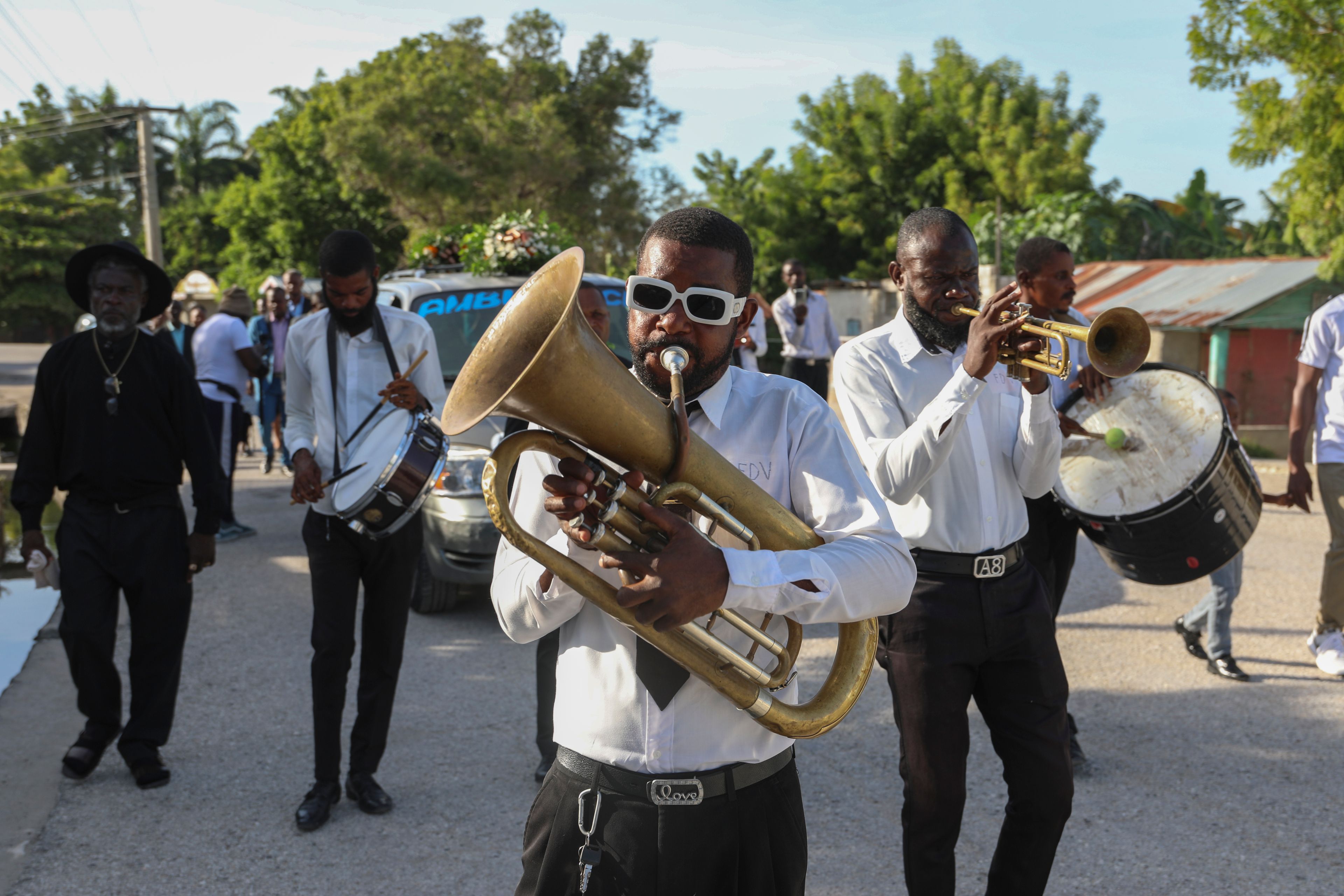 Musicians perform during the funeral of Jean Louis Jeune Gracien, who was killed during an attack by armed gangs, in Pont-Sonde, Haiti, Tuesday, Oct. 8, 2024. (AP Photo/Odelyn Joseph)