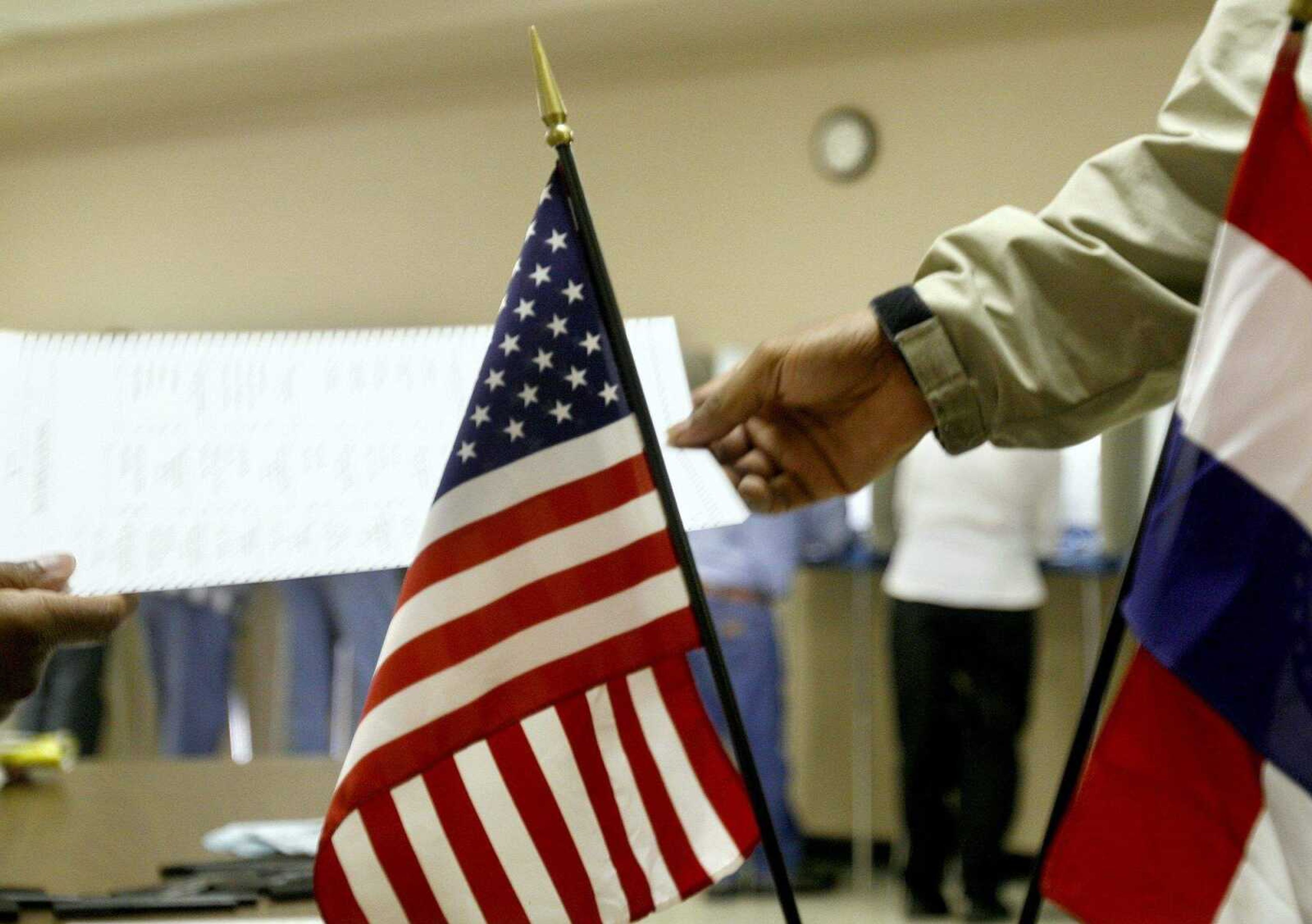 ELIZABETH DODD ~ edodd@semissourian.com
Election officials hand ballots to voters Tuesday at the Red Star Baptist Church in Cape Girardeau.