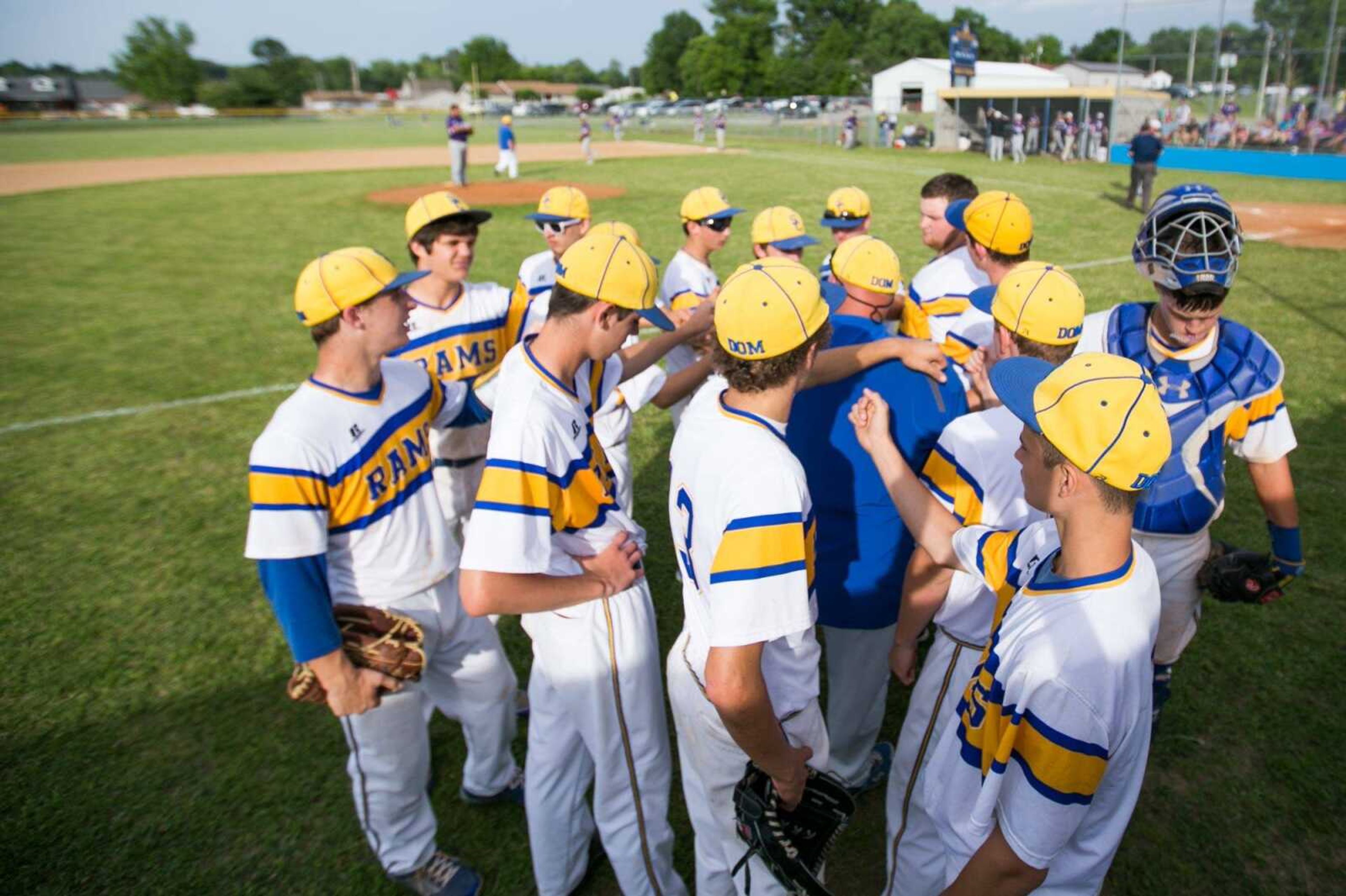 Scott City players join in a huddle with coach Jim May between innings during a Class 3 quarterfinal Wednesday, May 27, 2015 in Scott City. (Glenn Landberg)