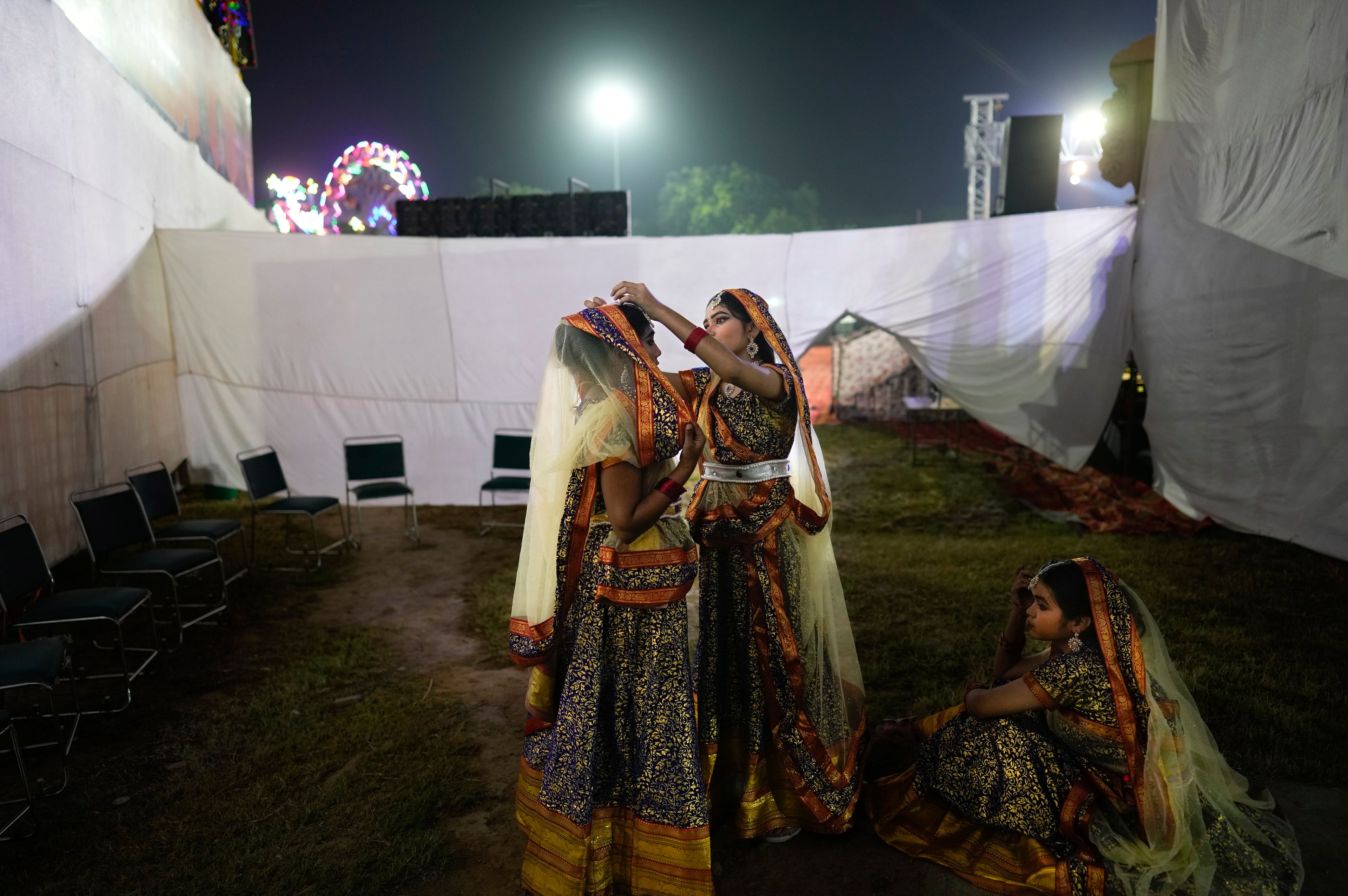 Actors get ready backstage before the start of Ramleela, a dramatic folk re-enactment of the life of Hindu god Rama according to the ancient Hindu epic Ramayana, in New Delhi, India, Saturday, Oct. 5, 2024. (AP Photo/Manish Swarup)