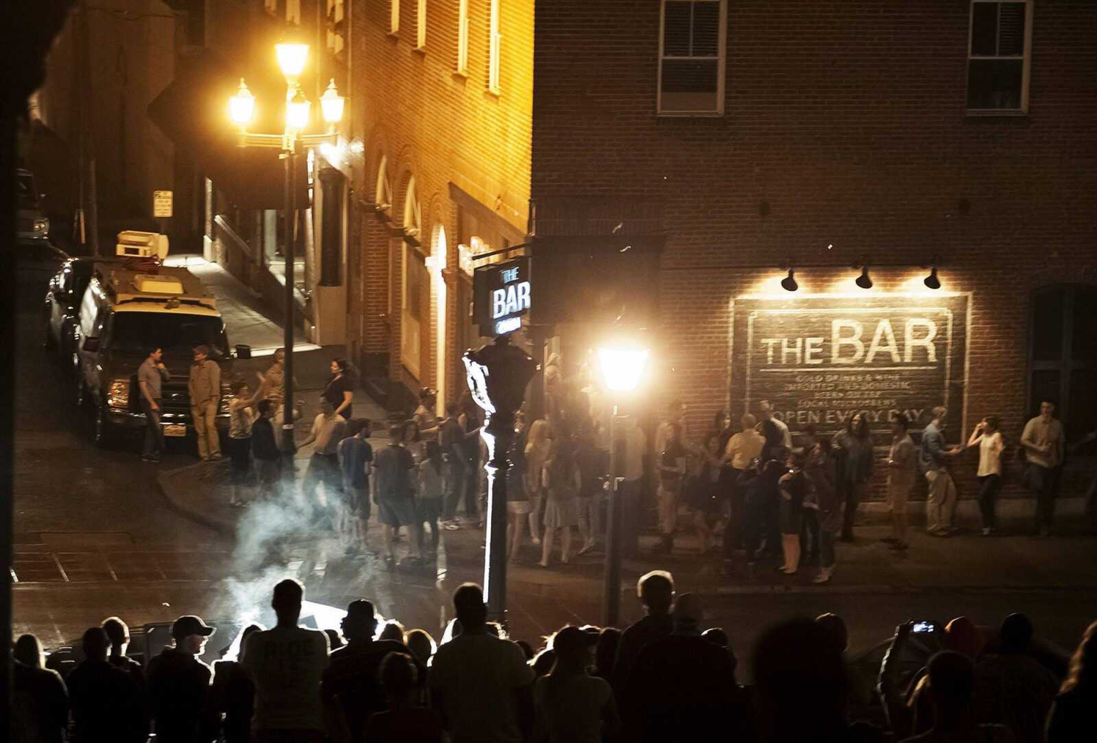 Spectators watch from the steps of the Common Pleas Courthouse as actor Ben Affleck films a scene in September 2014 for the 20th Century Fox feature film "Gone Girl" in downtown Cape Girardeau. (Southeast Missourian file)