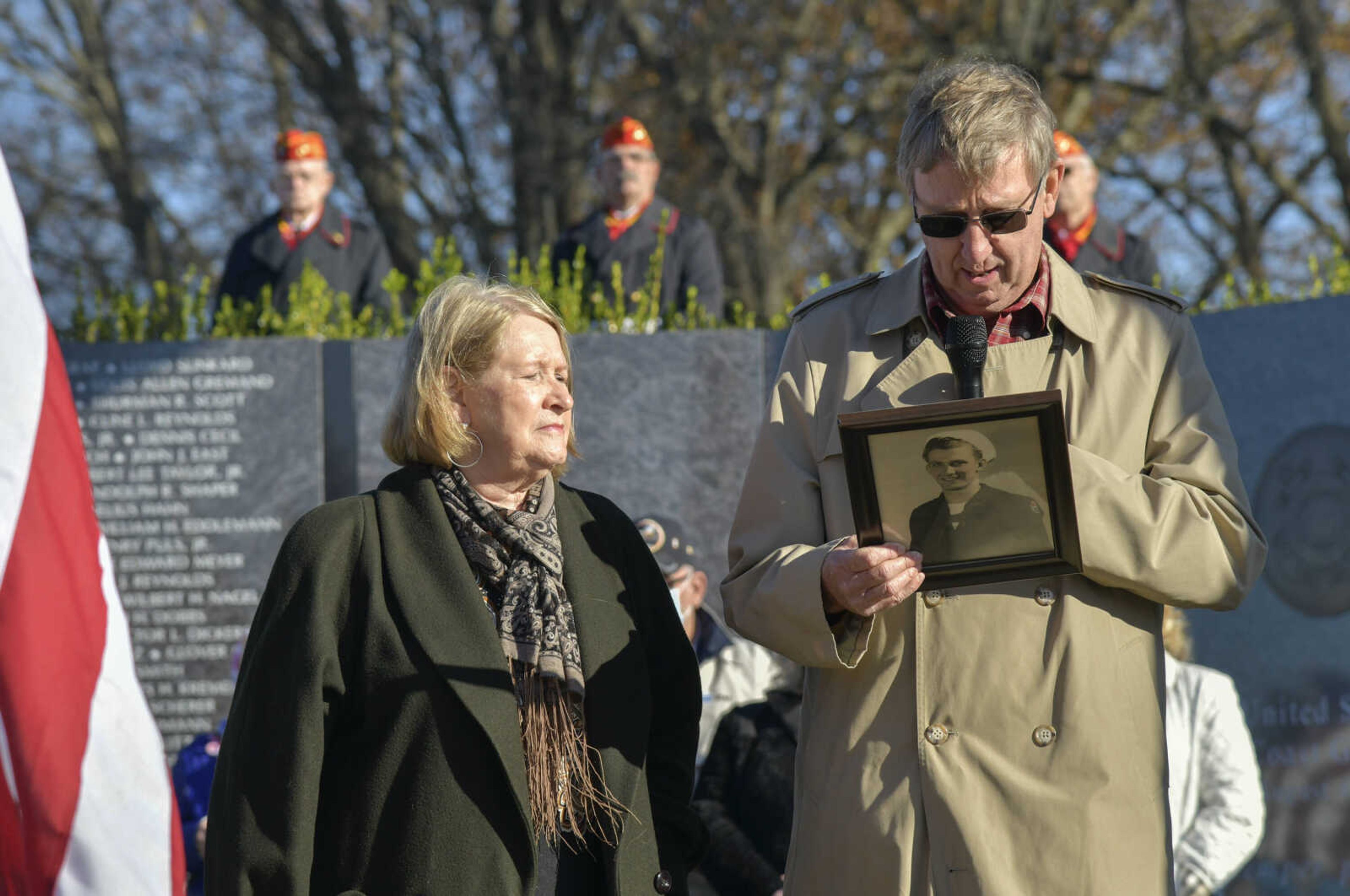 Robert Turner speaks about his father, WWII veteran Paul D. Turner, while holding a picture of him during the Veteran's Day flag presentation ceremony at Cape County Park North in Cape Girardeau on Wednesday, Nov. 11, 2020.