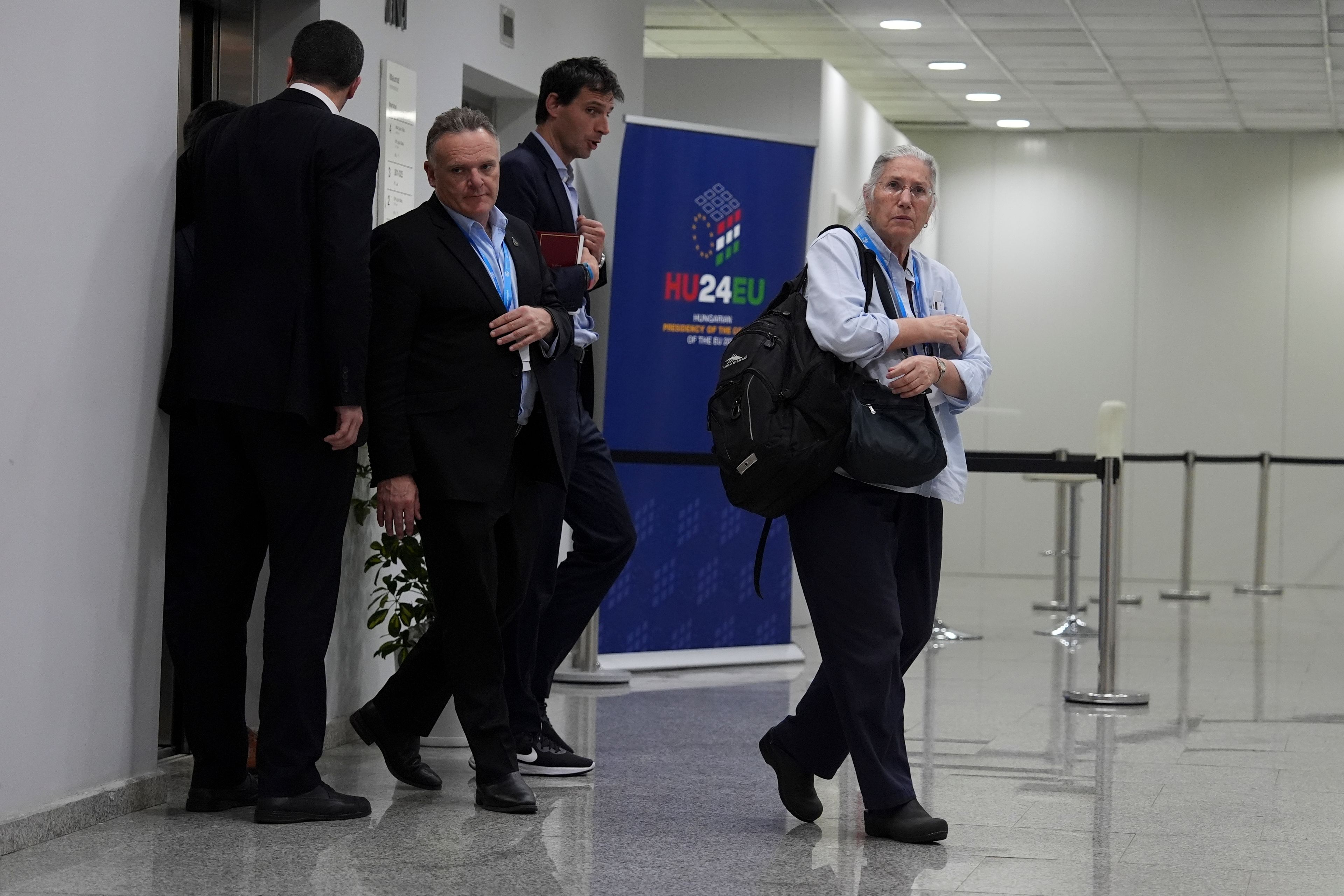 U.S. Deputy Climate Envoy Sue Biniaz, right, and Wopke Hoekstra, EU climate commissioner, second from right, walk out of an elevator during the COP29 U.N. Climate Summit in the early hours of Saturday, Nov. 23, 2024, in Baku, Azerbaijan. (AP Photo/Joshua A. Bickel)