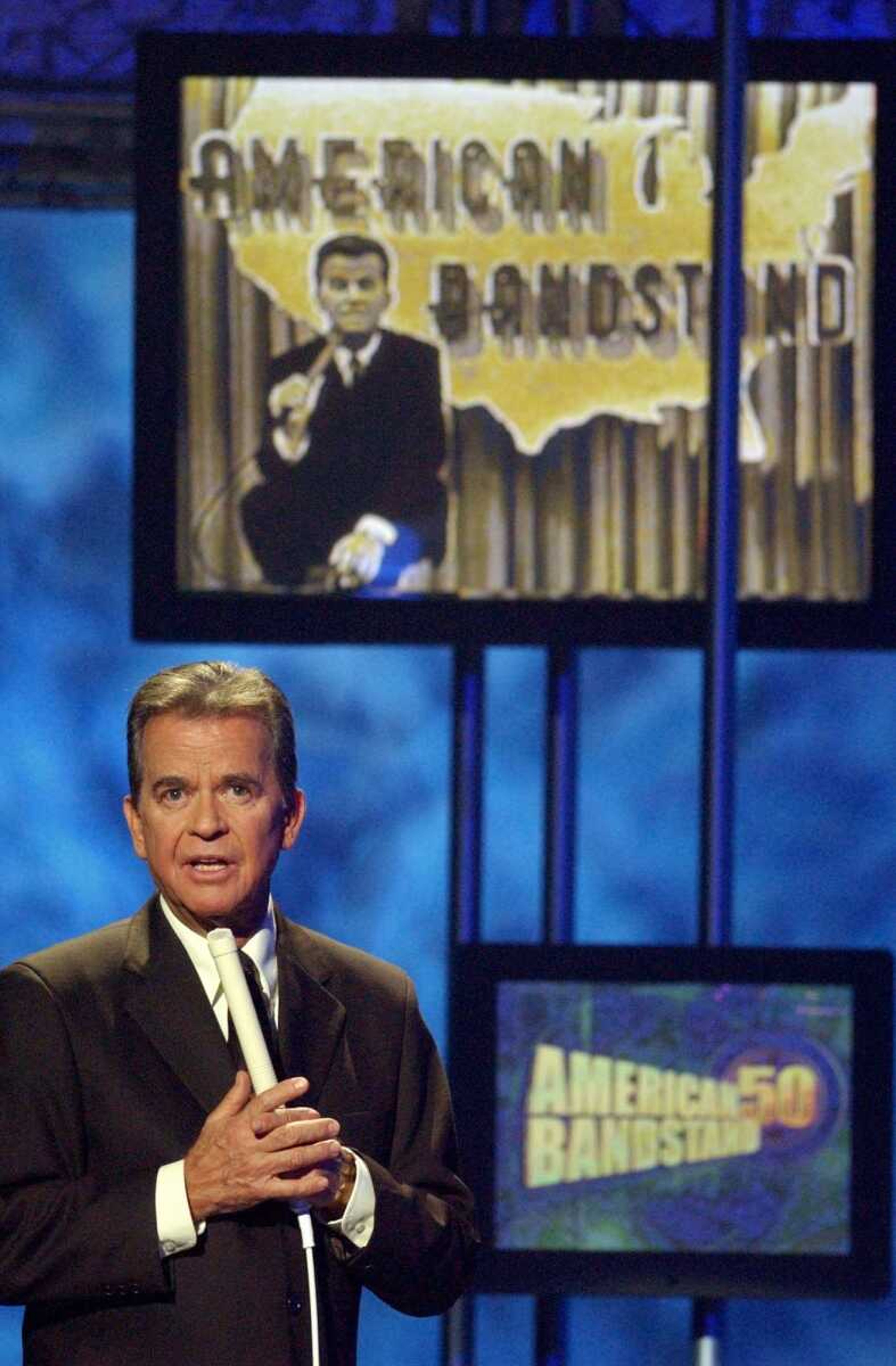 FILE - In this April 20, 2002 file photo, Dick Clark, host of the American Bandstand television show, introduces entertainer Michael Jackson on stage during taping of the show's 50th anniversary special in Pasadena, Calif. Clark, the television host who helped bring rock `n' roll into the mainstream on "American Bandstand," died Wednesday, April 18, 2012 of a heart attack. He was 82. (AP Photo/Kevork Djansezian, File)