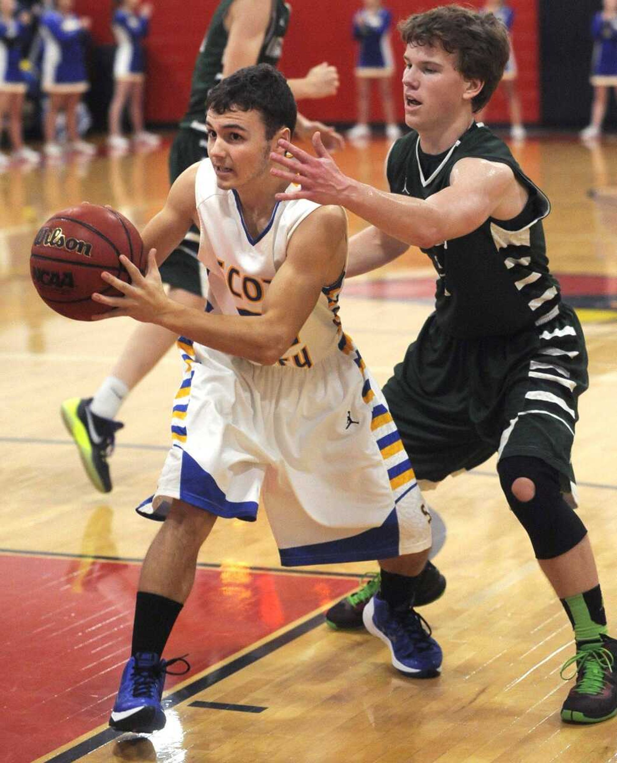 Scott City's Nick Bickings looks to pass as Perryville's McGwire Bartley defends during the first quarter of the championship game in the Woodland Invitational on Friday, Dec. 4, 2015 in Marble Hill, Missouri. (Fred Lynch)