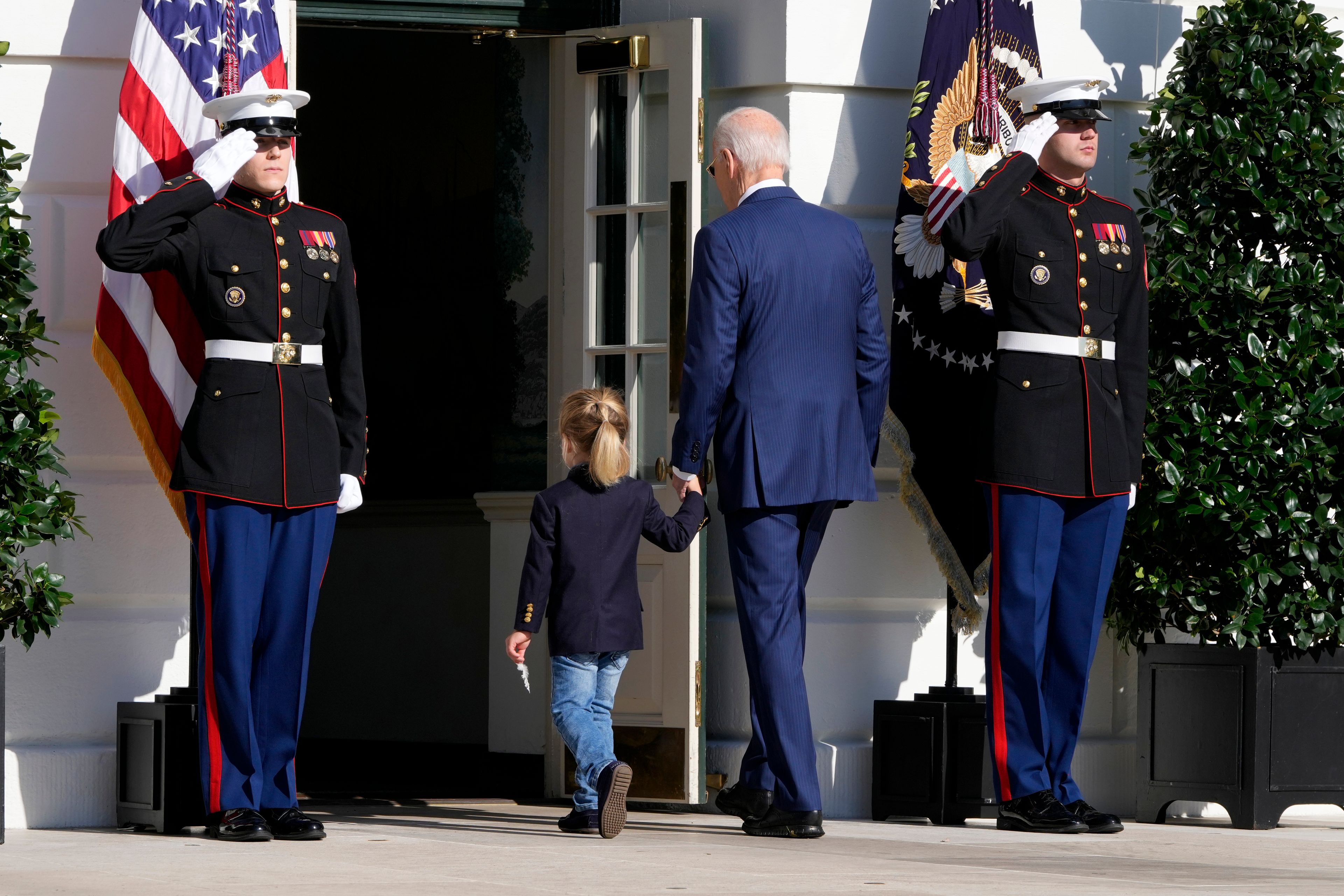 President Joe Biden, center right, departs with his grandson Beau Biden after pardoning the national Thanksgiving turkeys during a ceremony on the South Lawn of the White House in Washington, Monday, Nov. 25, 2024. (AP Photo/Mark Schiefelbein)