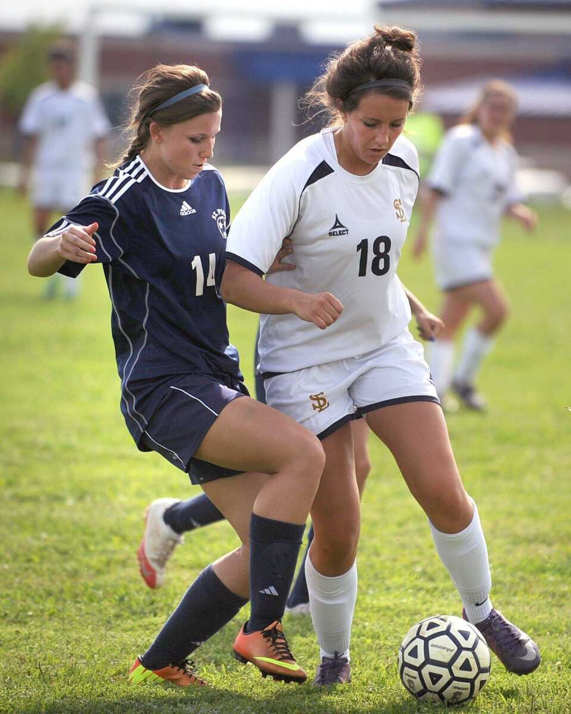 Saxony&#8217;s Lauren Hecht tries to get past St. Pius&#8217; Meghan Karoly during the first half.