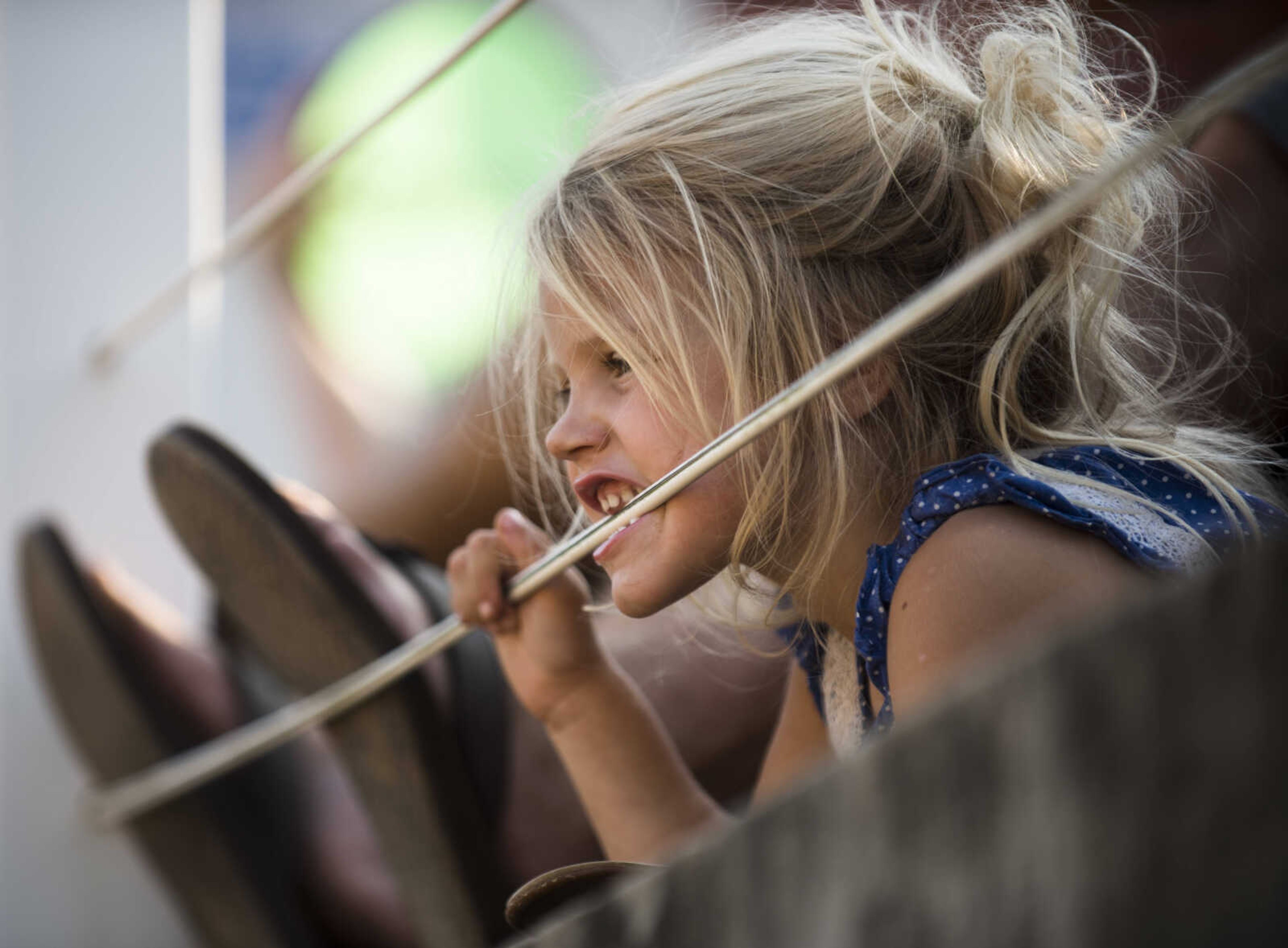 Kate Wachter, 3, watches the mule jumping event Sept. 23, 2017 at the East Perry Community Fair in Altenburg, Missouri.