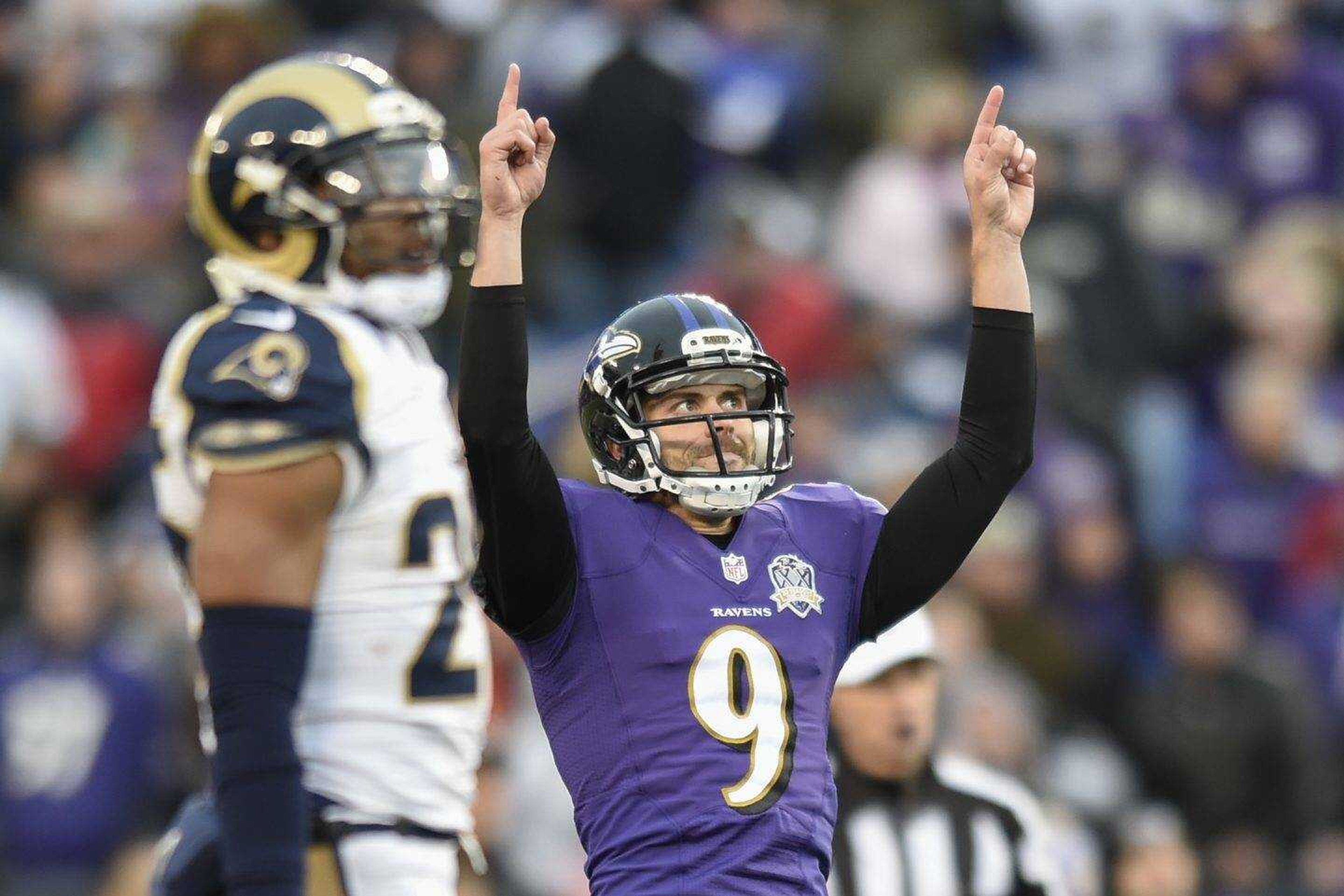 Ravens kicker Justin Tucker celebrates his game-winning field goal aginst the Rams. (Gail Burton ~ Associated Press)