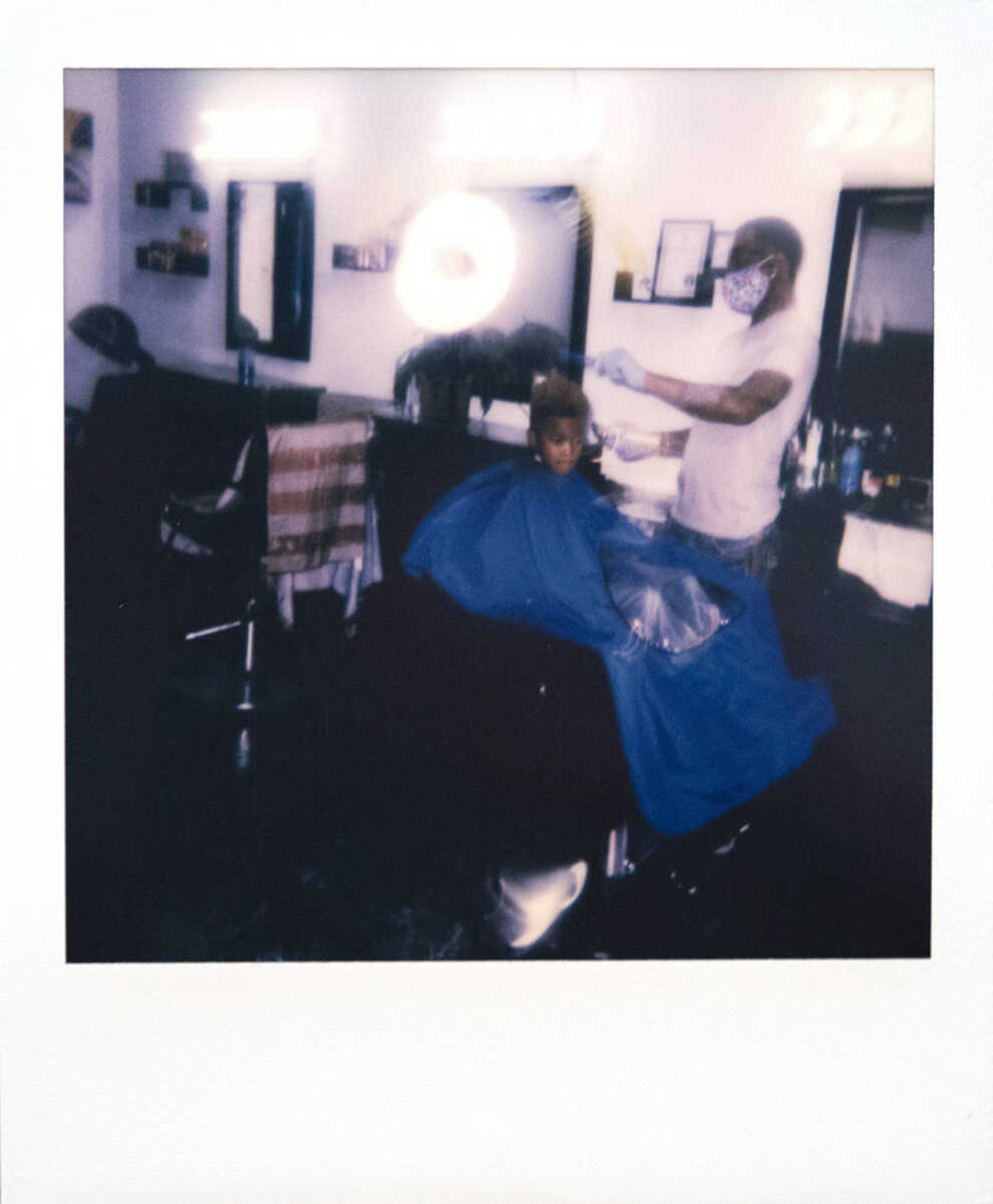 Cosmologist Antonio Johnson, owner of A+ Kutz, wears a face mask while cutting the hair of Omiere Johnson, 6, of Cape Girardeau, on Tuesday, March 17, 2020, at the shop in Cape Girardeau. Antonio, originally from Sikeston, Missouri, and now Cape Girardeau, said he usually always wears gloves while cutting hair, but has been wearing the face mask since the end of last week due to concerns about coronavirus. "I'm trying to keep myself safe," Antonio said.