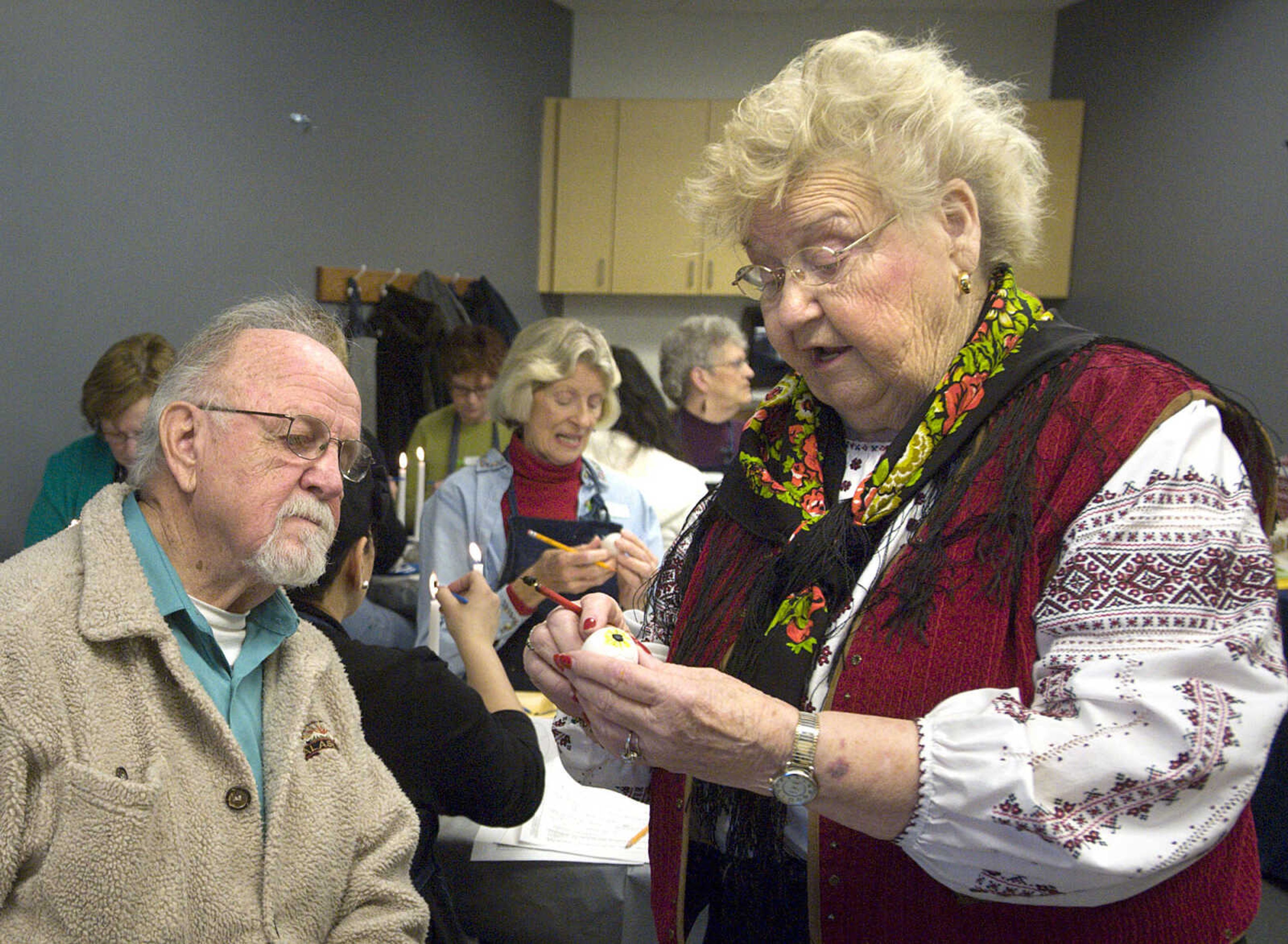 LAURA SIMON ~ lsimon@semissourian.com
Bernard Letassy watches instructor Barb Duncan apply dye to her egg Tuesday, March 19, 2013 during the Wonderful World of Pysanky workshop at Southeast Missouri State University's River Campus.