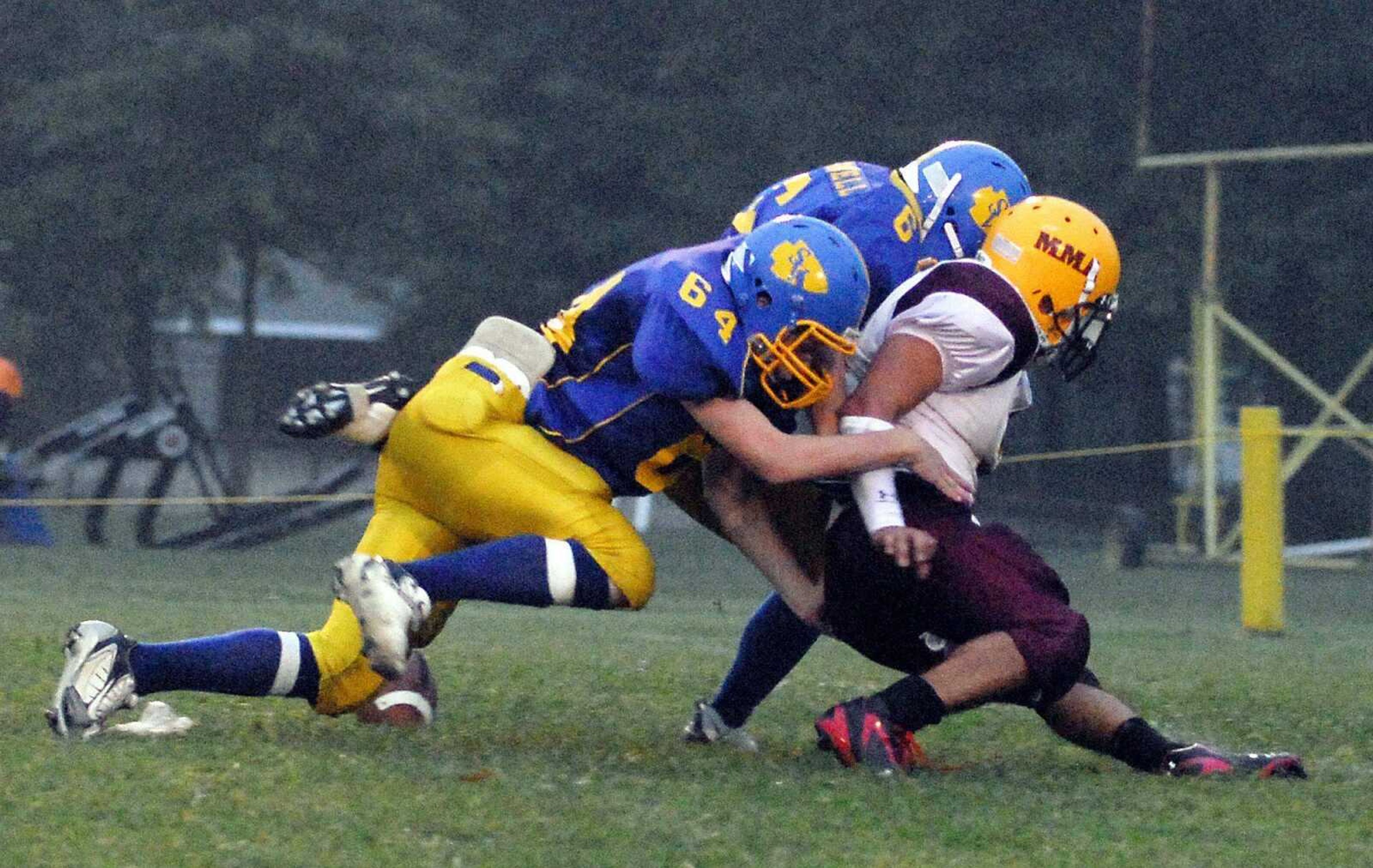 St. Vincent defenders Lucas Carroll (64) and Mitchell Presnell tackle Missouri Military's Derek Kantorski during their game Friday in Perryville, Mo.