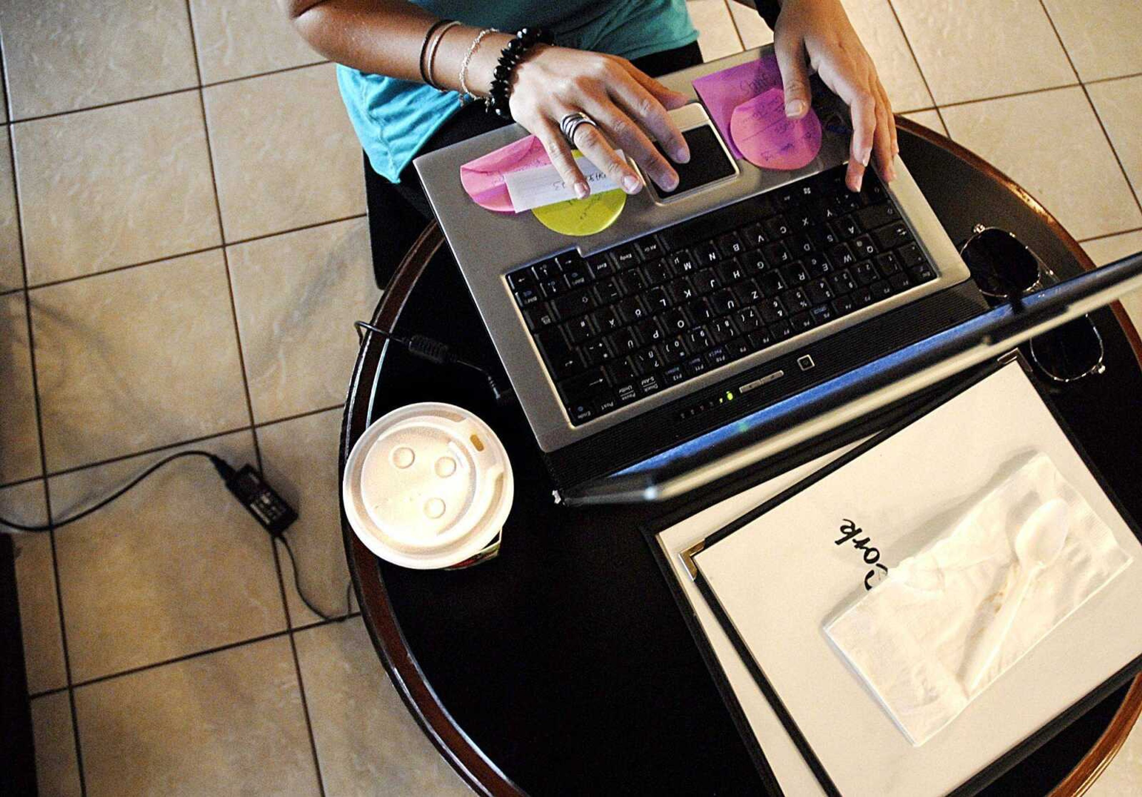 With a warm beverage at her side, Tanja Schroot accessed the Internet using the wireless connection at Cup 'N' Cork on Friday. (Aaron Eisenhauer)