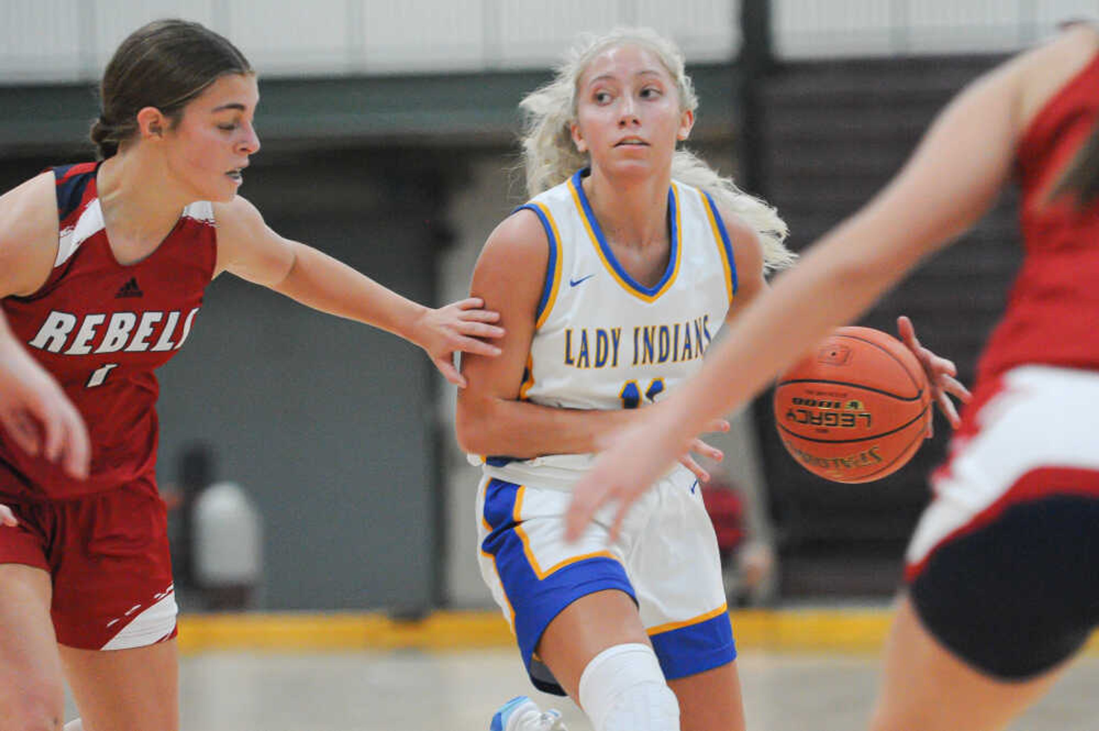 St. Vincent’s Brie Rubel, center, dribbles in traffic during an Amped Lifestyle Girls Basketball Shootout game between the St. Vincent Indians and the Park Hills Central Rebels on Saturday, Nov. 23, at the Farmington Civic Center in Farmington. St. Vincent defeated Park Hills Central 56-33.