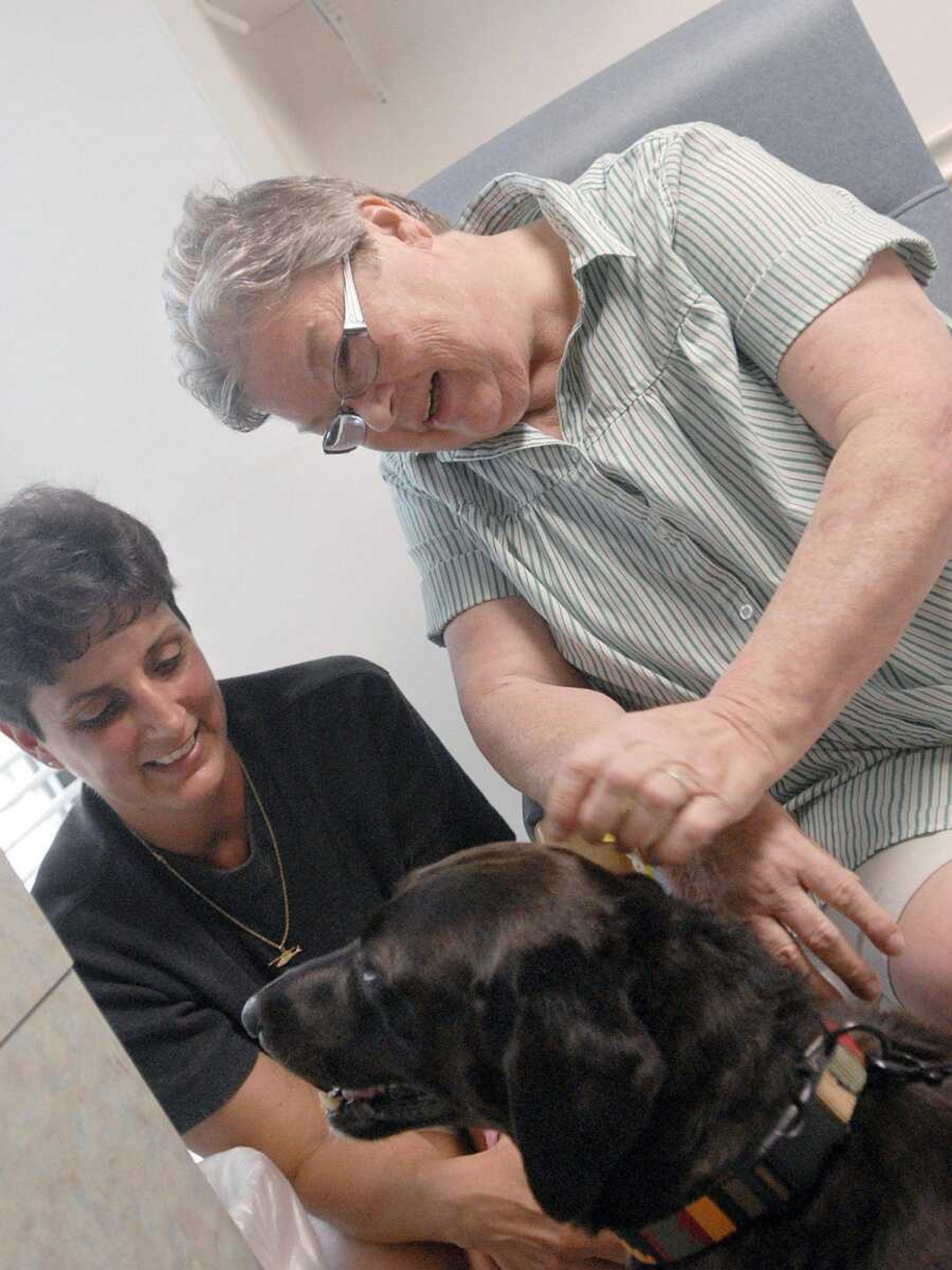 Sandy Grebing of Jackson, left, and her therapy dog Jasmine visit Geri Buchheit on June 20 at Saint Francis Medical Center. (Laura Simon)