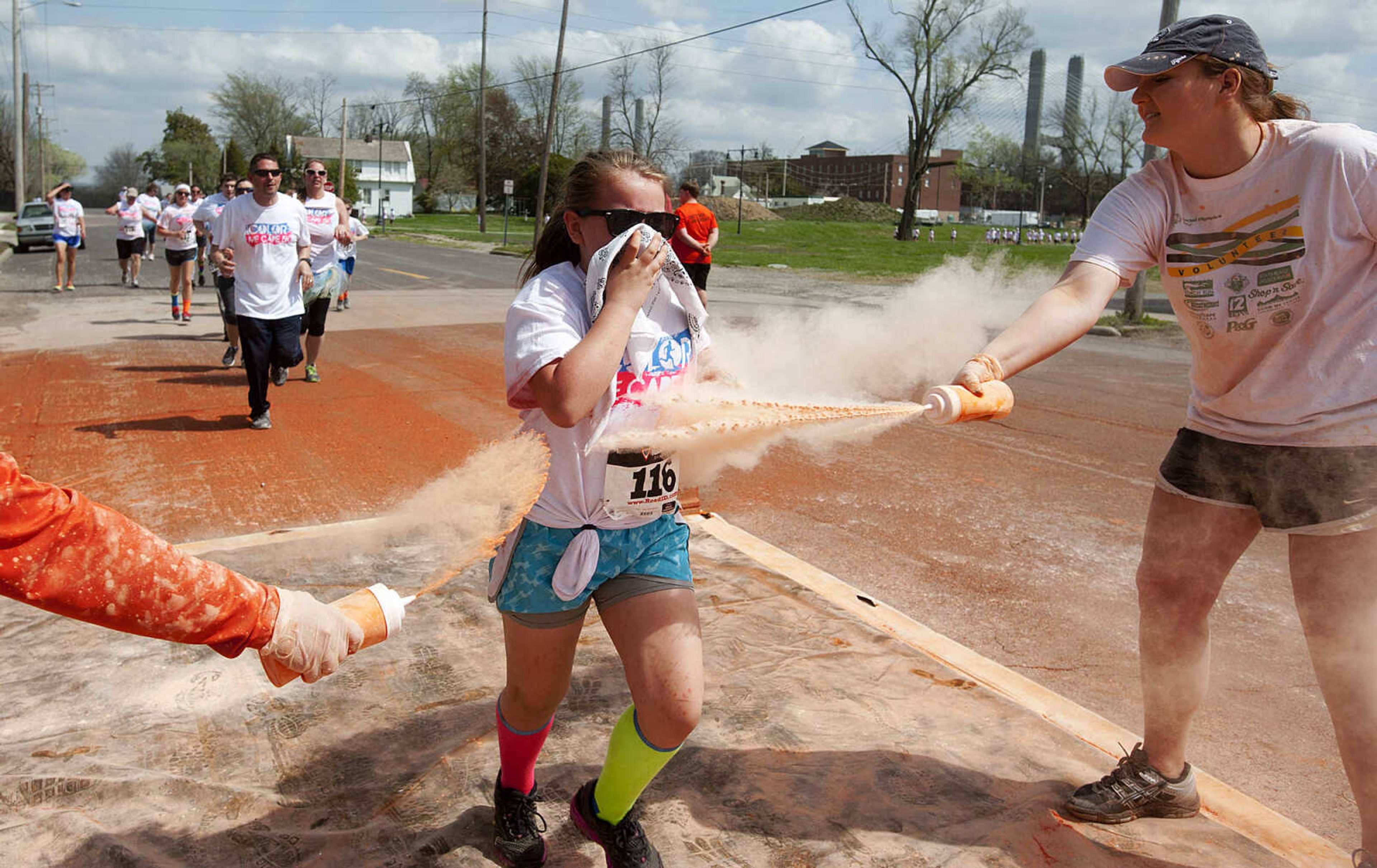 ADAM VOGLER ~ avogler@semissourian.com
Participants in the Color Me Cape 5k run through the orange color station at the corner of Good Hope Street and Fountain Street Saturday, April 12, in Cape Girardeau.