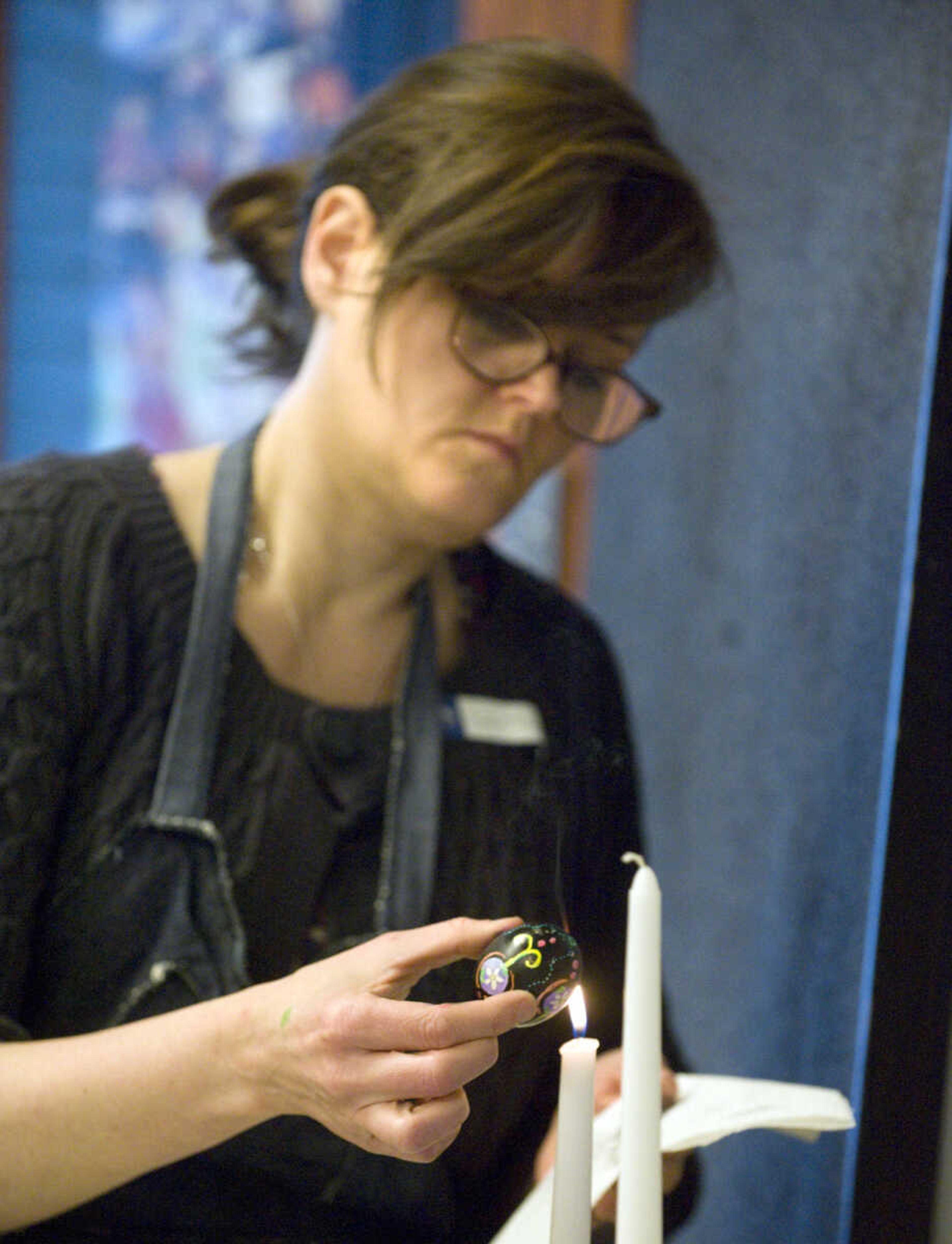 LAURA SIMON ~ lsimon@semissourian.com
Jenny Turner melts the beeswax off of her dyed egg Tuesday, March 19, 2013 during the Wonderful World of Pysanky workshop at Southeast Missouri State University's River Campus.