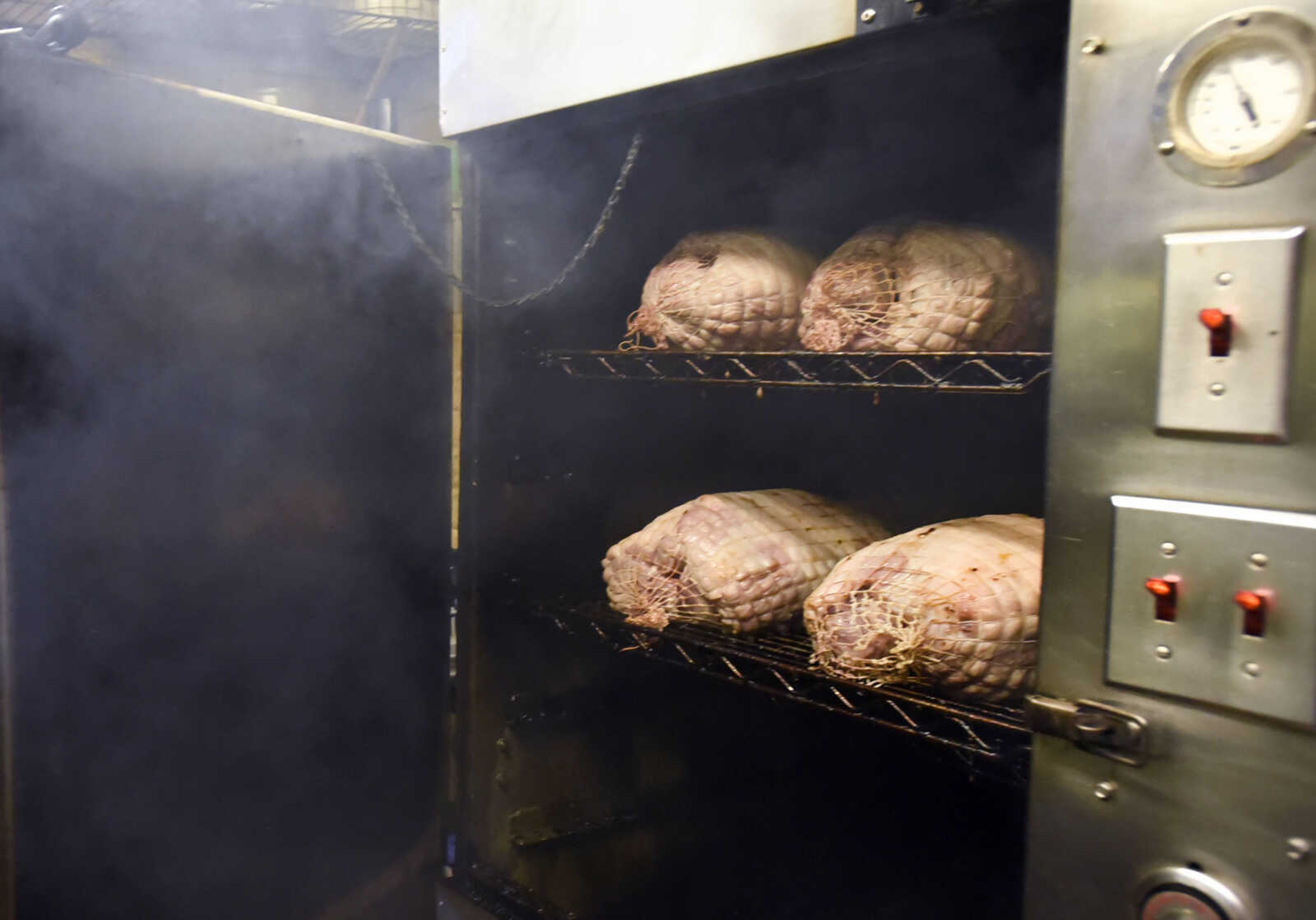 Pork butts cook in the smoker at the Pilot House in Cape Girardeau.