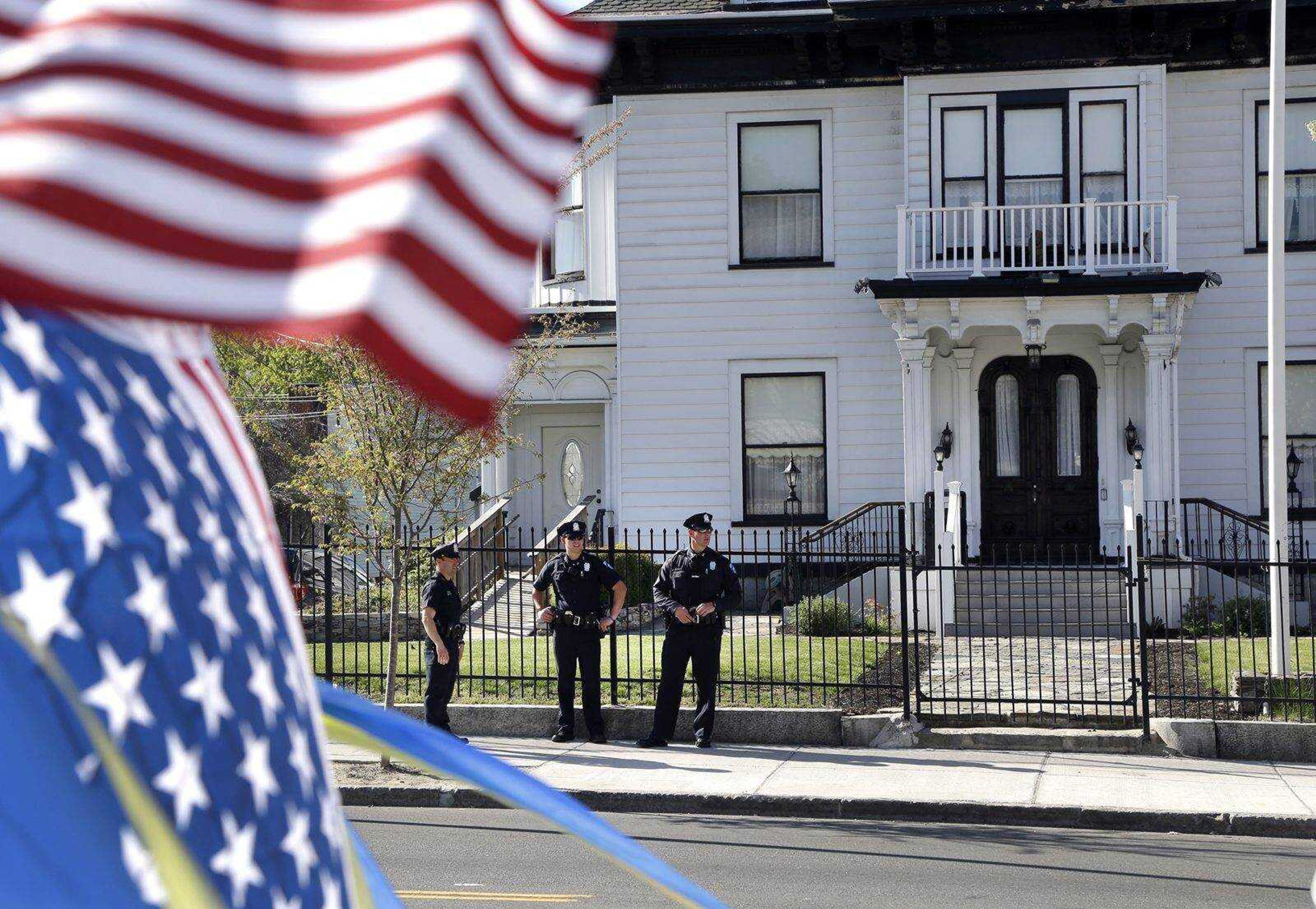 Police keep watch outside Graham, Putnam, and Mahoney Funeral Parlors on Monday in Worcester, Mass., where the body of killed Boston Marathon bombing suspect Tamerlan Tsarnaev is being prepared for burial. (Elise Amendola ~ Associated Press)