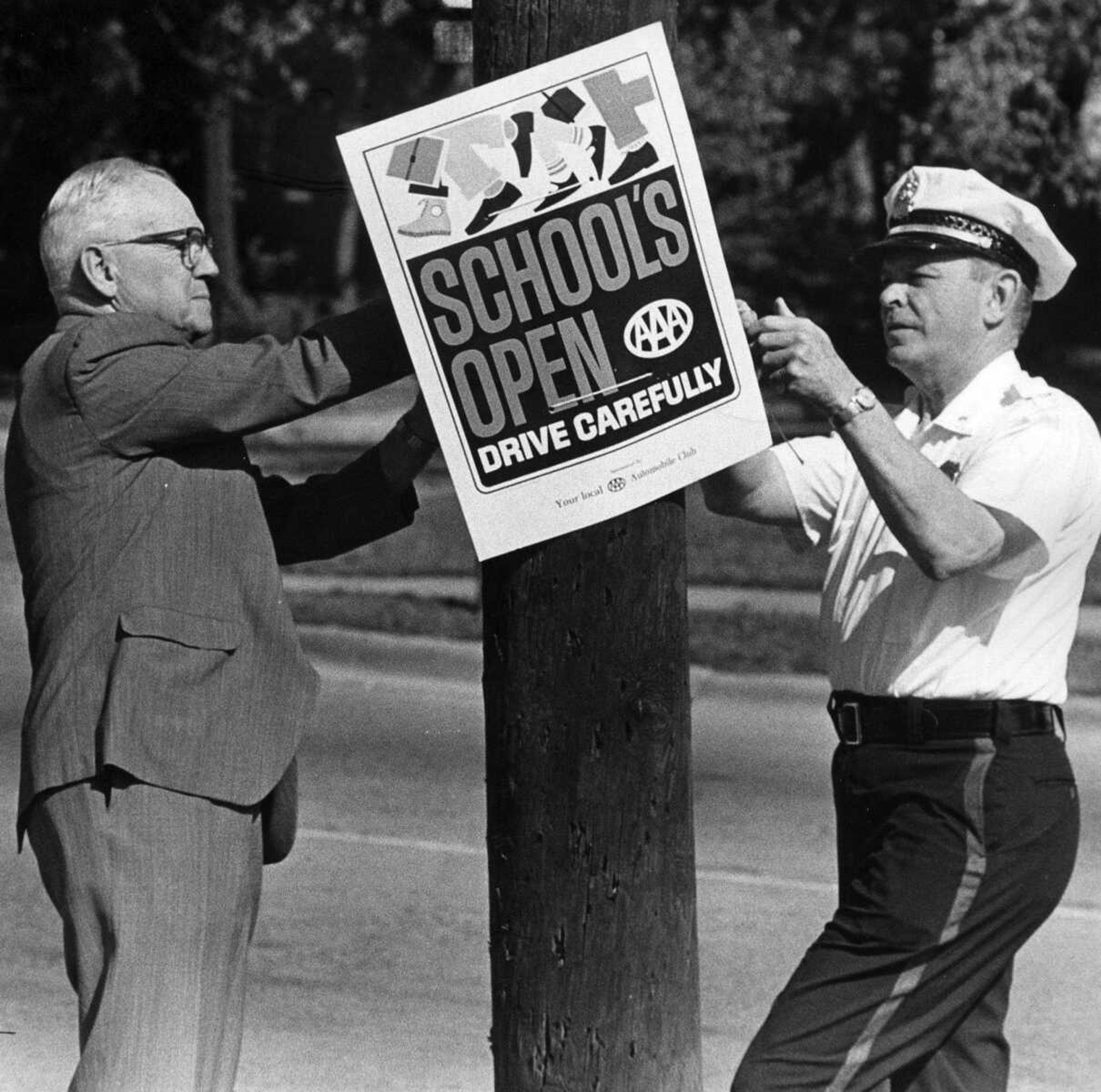 SOUTHEAST MISSOURIAN ~ photos@semissourian.com
Aug. 30, 1967
Mayor J. Hugh Logan, left, and Police Chief Beard hang a sign to push school safety.