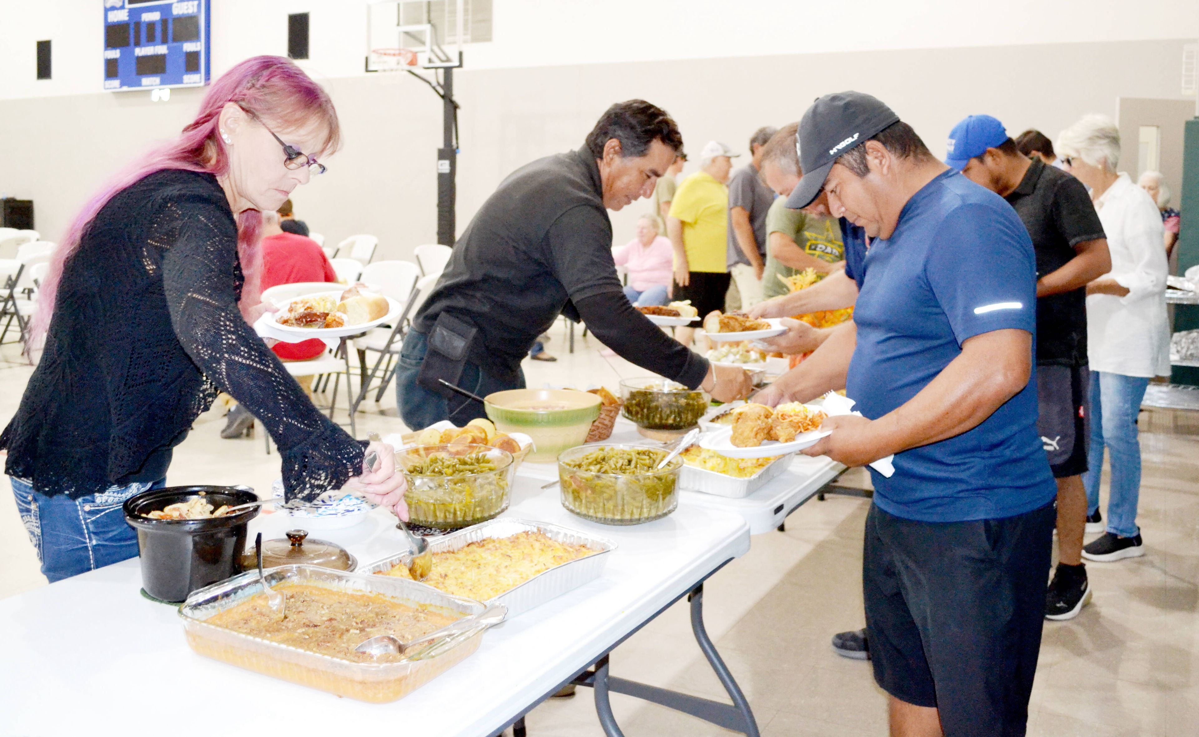 Employees of Tinsley’s Amusements of High Hill fill their plates as they move through the line Thursday, Sept. 26, at First Baptist Church in Sikeston. For about 17 years, the Arbutus class at First Baptist Church has provided a homecooked meal for those who work during the weeklong Sikeston American Legion Cotton Carnival, which marked its 80th year.