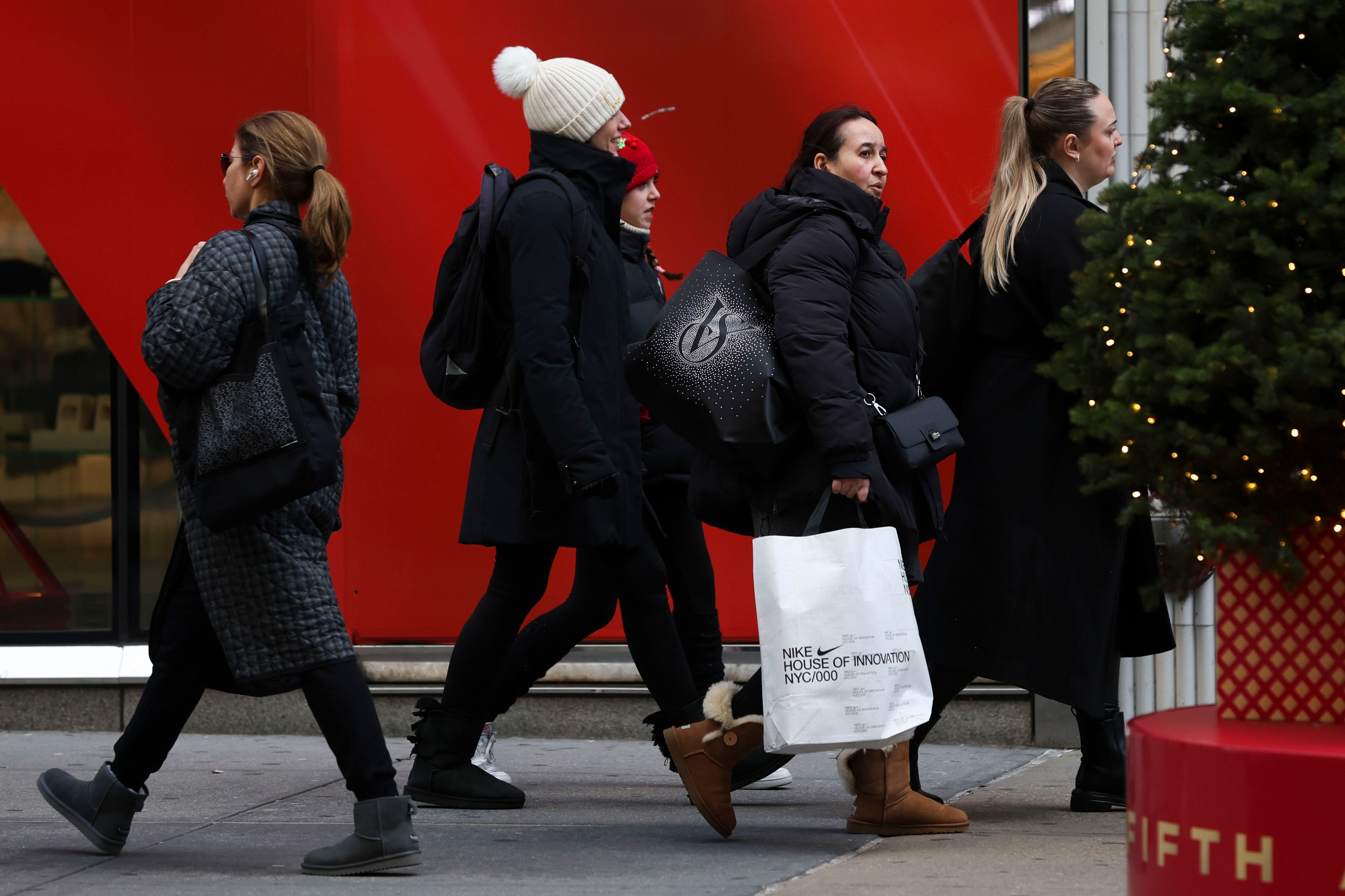 Shoppers walk along Fifth Avenue, Friday, Nov. 29, 2024, in New York. (AP Photo/Heather Khalifa)