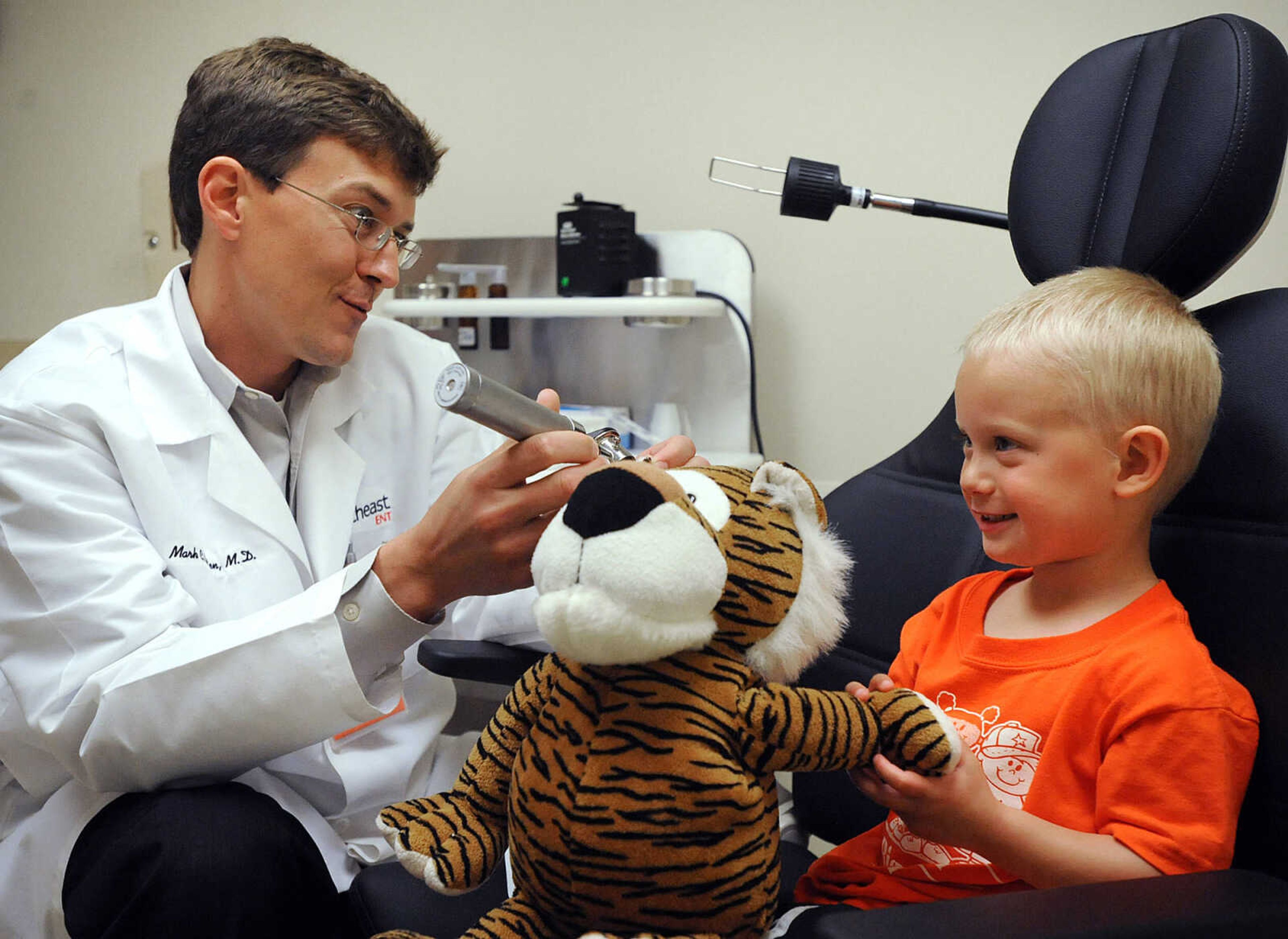 LAURA SIMON ~ lsimon@semissourian.com

Cambden Livesay holds his stuffed tiger Howard while Dr. Mark C. Rusten checks his ears Tuesday morning, April 30, 2013 at SoutheastHEALTH Primary Care in Cape Girardeau. Big Stuff preschool students got to bring their stuffed animals, ranging from teddy bears to tigers, in for exams Tuesday. Dr. Danette Miller organized the event. "I think it was a success," said Miller. "That was the point for them to come and not be afraid."