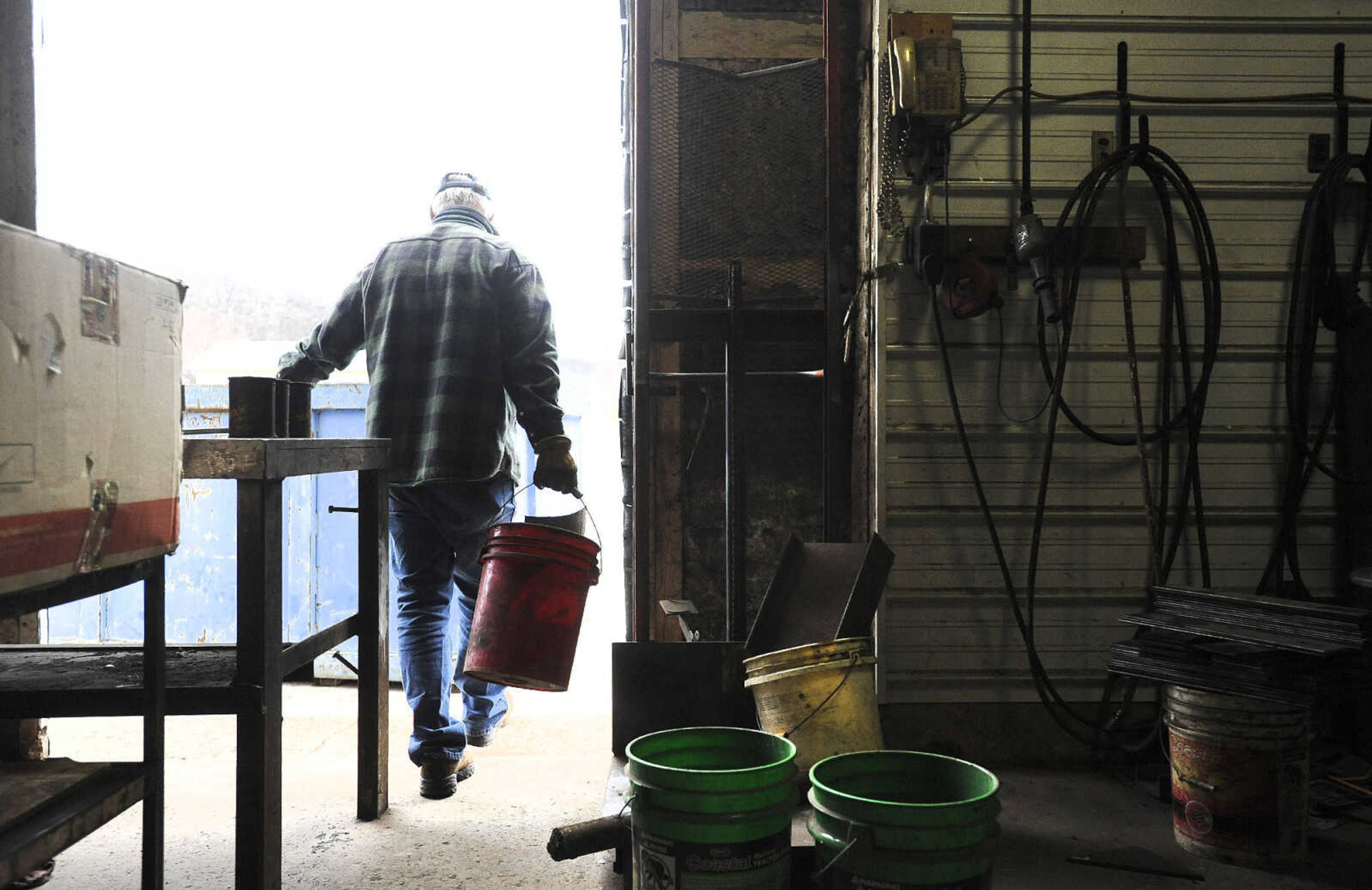 LAURA SIMON ~ lsimon@semissourian.com

Larry Stearns removes scrap metal from Ernst Service Station & Machine Shop to take to a higher location, Tuesday, Dec. 29, 2015, in McBride, Missouri.