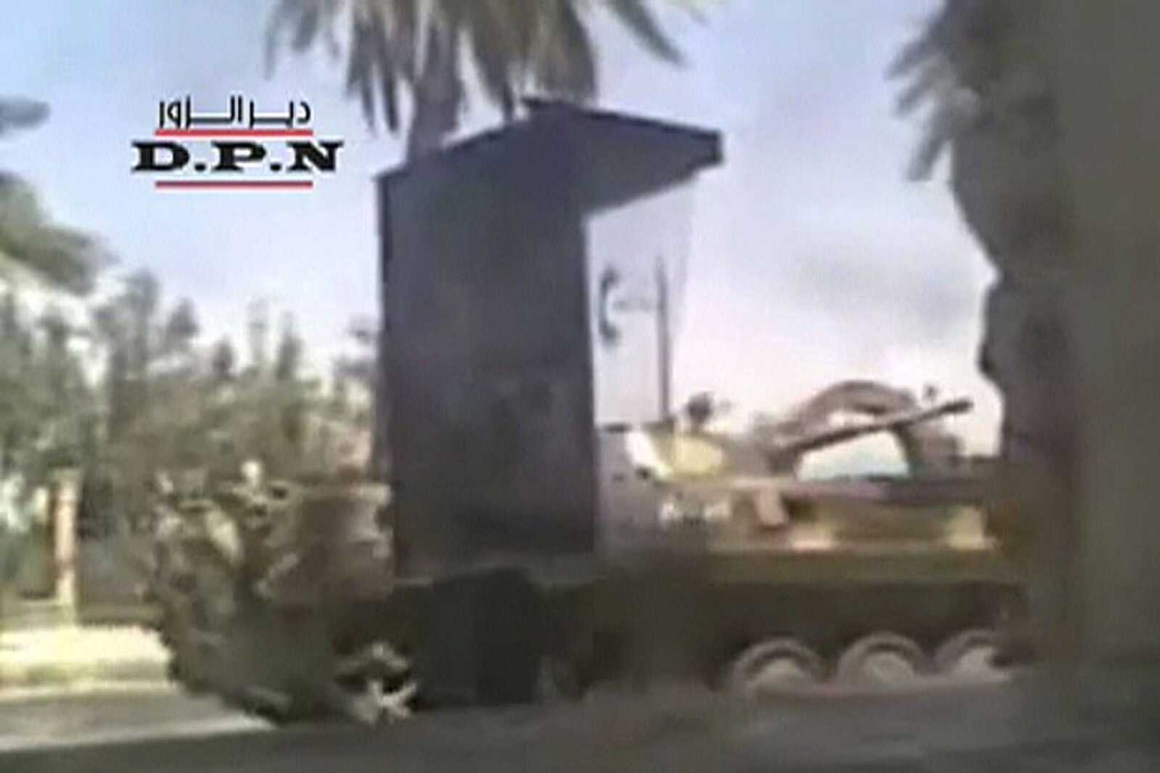 In this image made from amateur video released by DPN (Deir el-Zour Press news) and accessed via The Associated Press Television News on Monday Aug. 8, 2011, shows a Syria tank driving down a street in Deir el-Zour Syria on Sunday Aug. 7. 2011. The besieged Syrian city of Deir el-Zour came under fresh artillery fire early Monday as a deadly military assault left President Bashar Assad's regime increasingly isolated, with Arab nations forcefully joining the international chorus of condemnation for the first time. The renewed violence in the eastern city of Deir el-Zour comes a day after at least 42 people were killed there in an intensifying government crackdown on protesters. (AP Photo/DPN via APTN) THE ASSOCIATED PRESS CANNOT INDEPENDENTLY VERIFY THE CONTENT, DATE, LOCATION OR AUTHENTICITY OF THIS MATERIAL