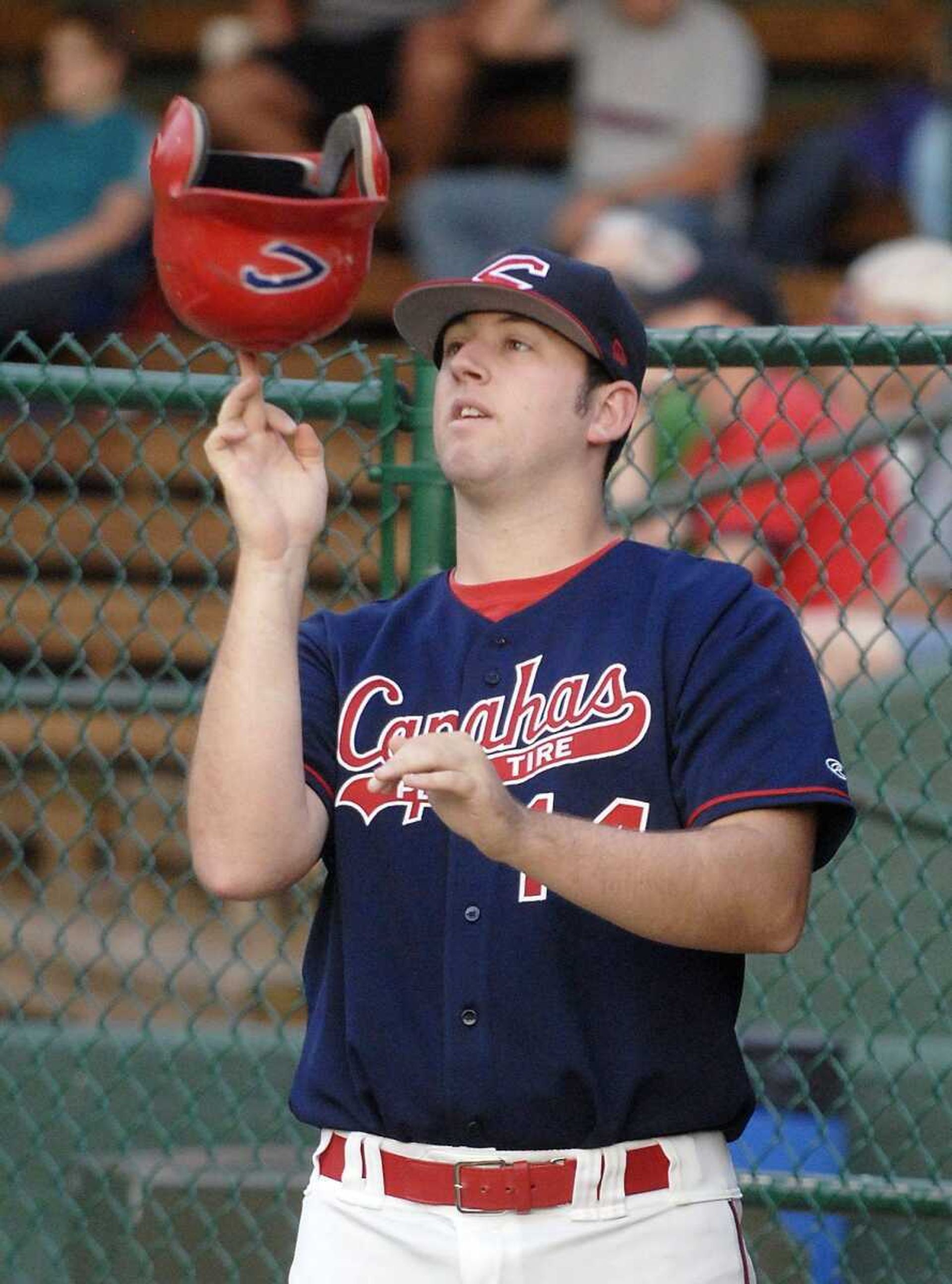 Jason Chavez spins a helmet on his finger during Friday's game.