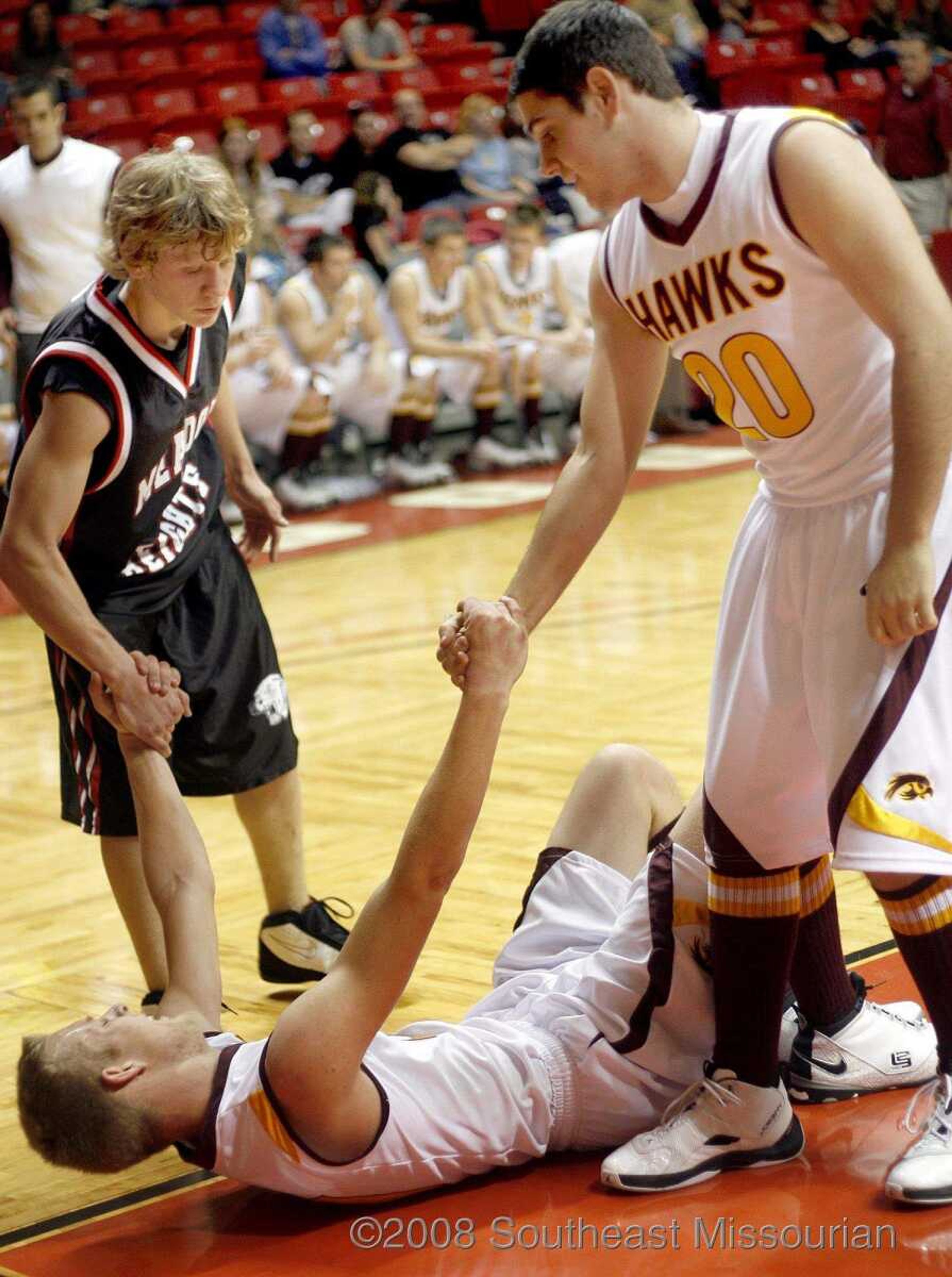 ELIZABETH DODD ~ edodd@semissourian.com
Meadow Heights' Derrick Wilfong, left, and Kelly's Mark Burger, right, help Levi Felter up after he tripped on a play in the second half.