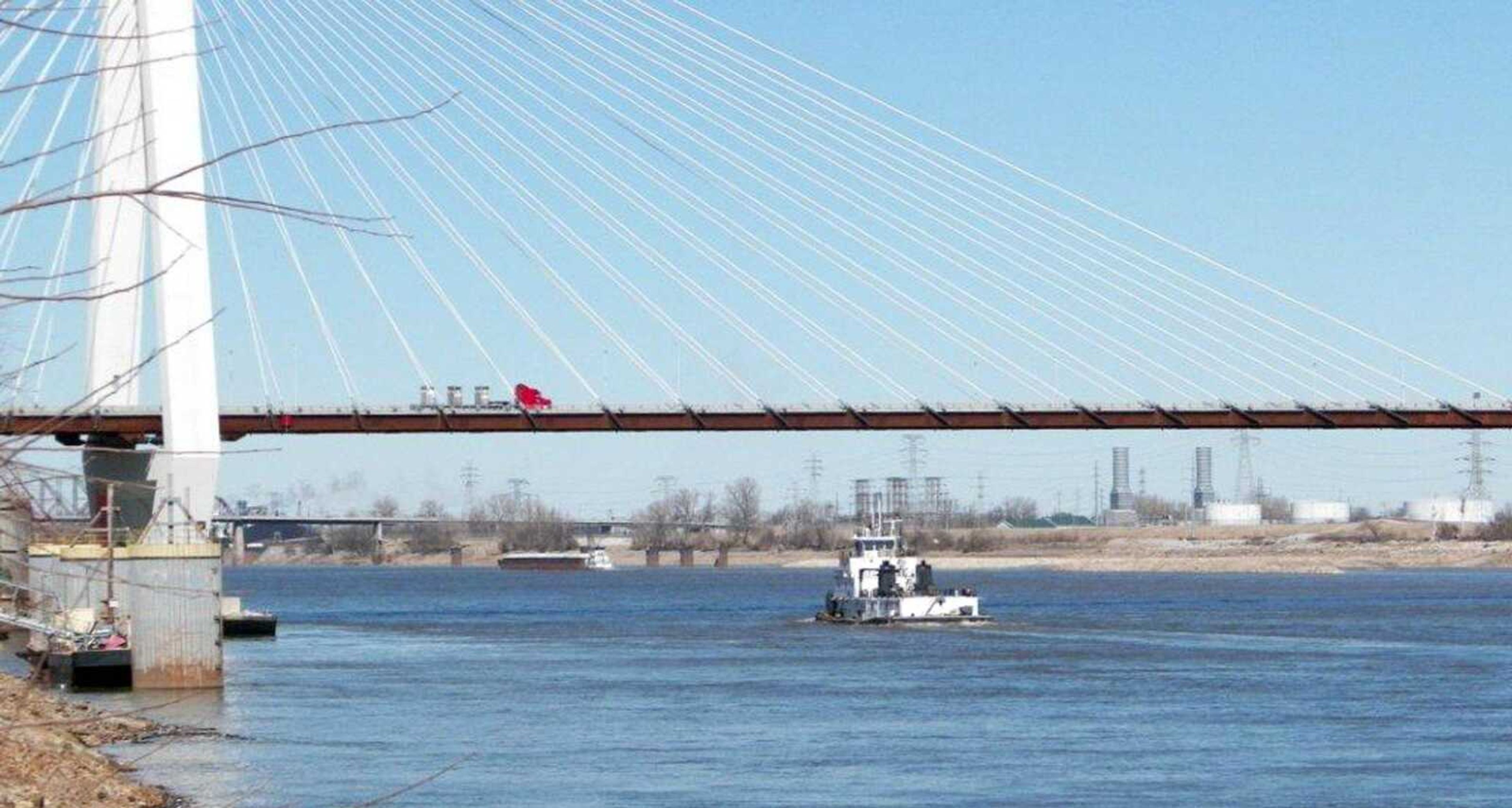 A tugboat travels along the Mississippi River near the Stan Musial Veterans Memorial Bridge on Friday. The Mississippi River is currently running low, and experts say that despite all the snow melt that will be coming this spring, there is little likelihood of significant flooding in the Midwest. (Jim Salter ~ Associated Press)