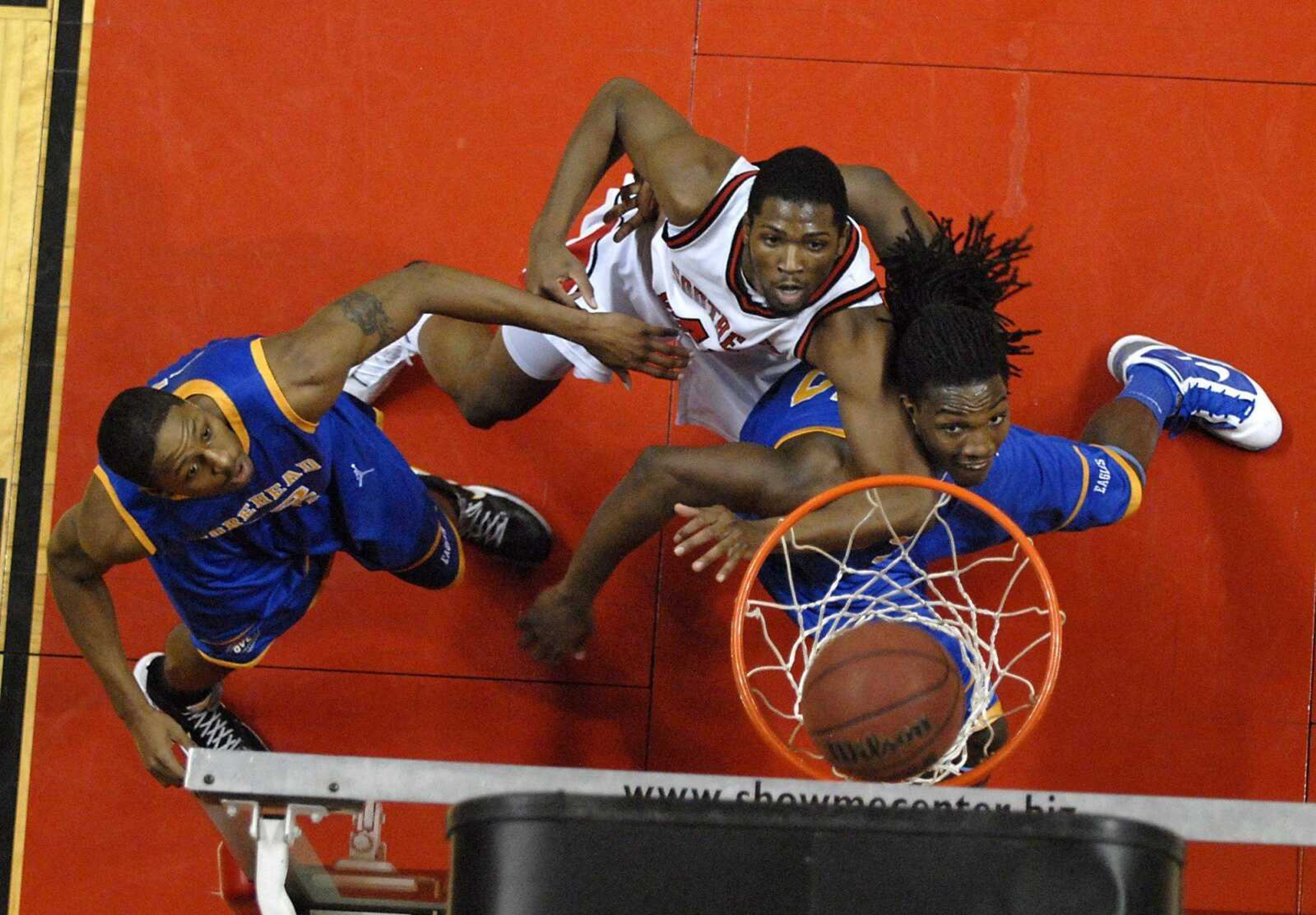 Southeast Missouri State's Leon Powell and Morehead State's Demonte Harper, left, and Kenneth Faried, right, fight to get into position for the rebound during the second half of a game on Thursday, Jan. 13, 2011, at the Show Me Center. SEMO lost 76-63. (Kristin Eberts)