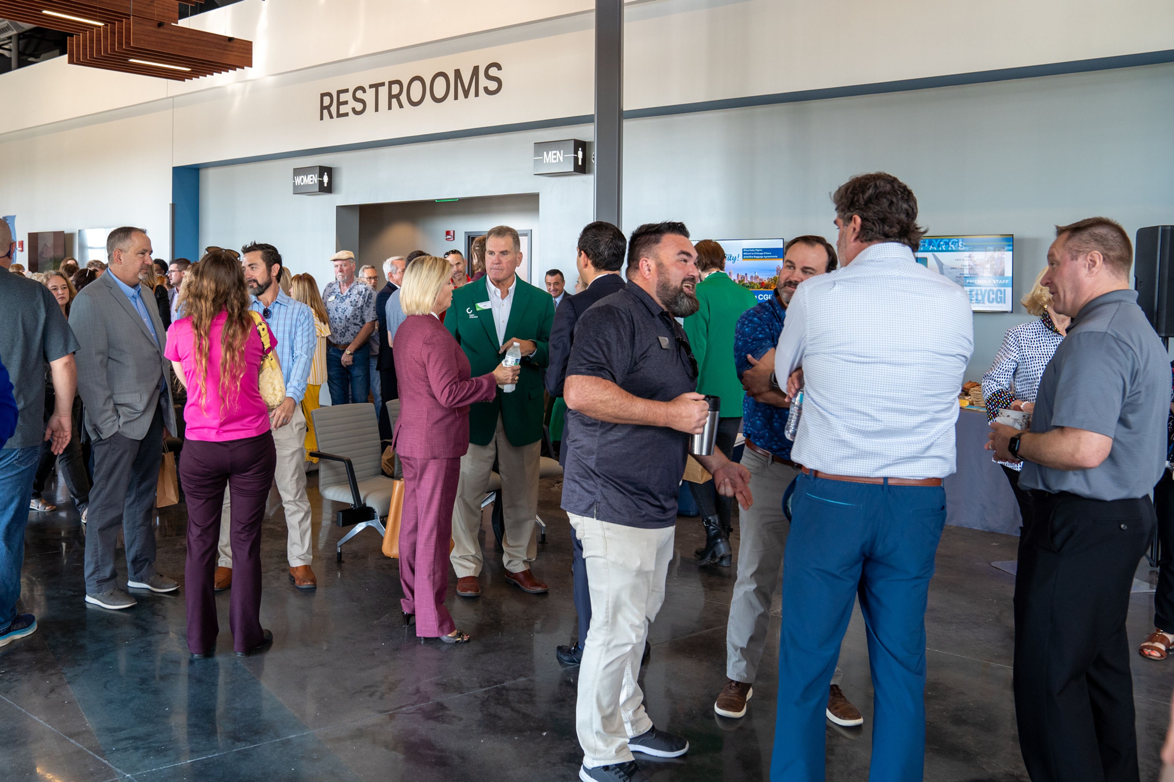 Attendees and city officials speak over refreshments before the news conference starts Tuesday, Oct. 1 at Cape Girardeau Regional Airport in Cape Girardeau.