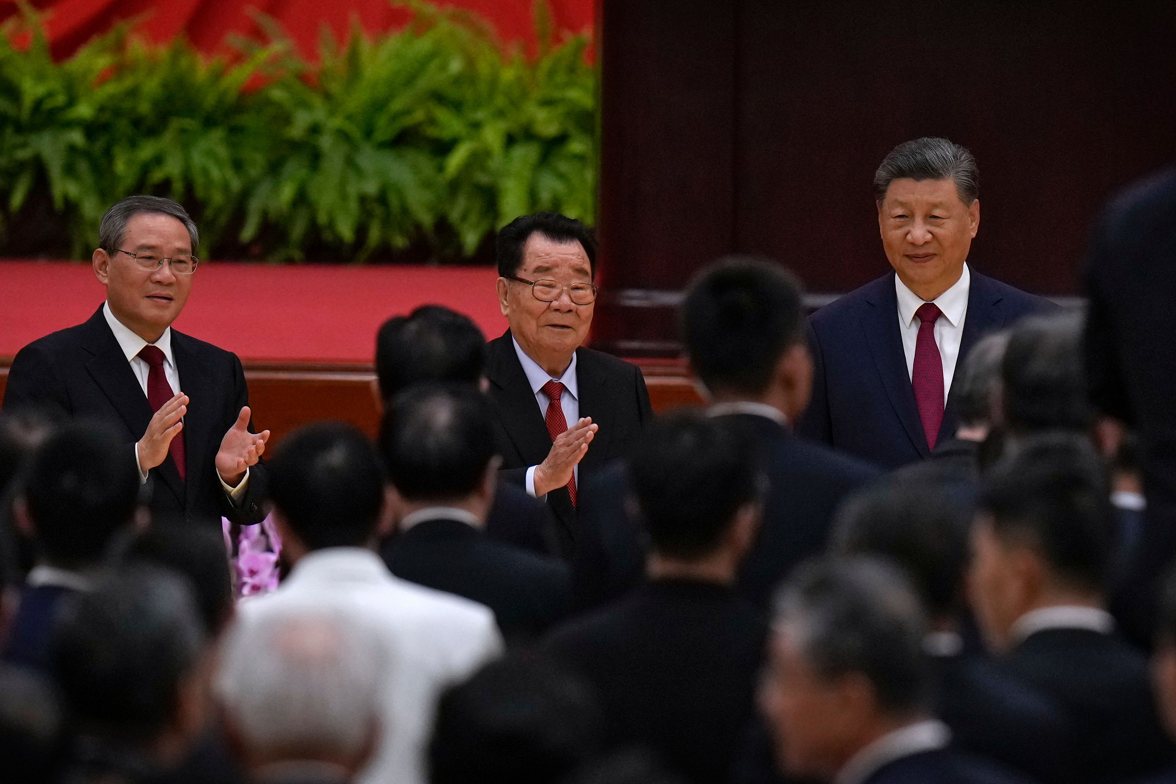 Leaders from right, Chinese President Xi Jinping, retired leader Li Ruihuan and Premier Li Qiang arrive for a dinner marking the 75th anniversary of the founding of the People's Republic of China, at the Great Hall of the People in Beijing, Monday, Sept. 30, 2024. (AP Photo/Andy Wong)