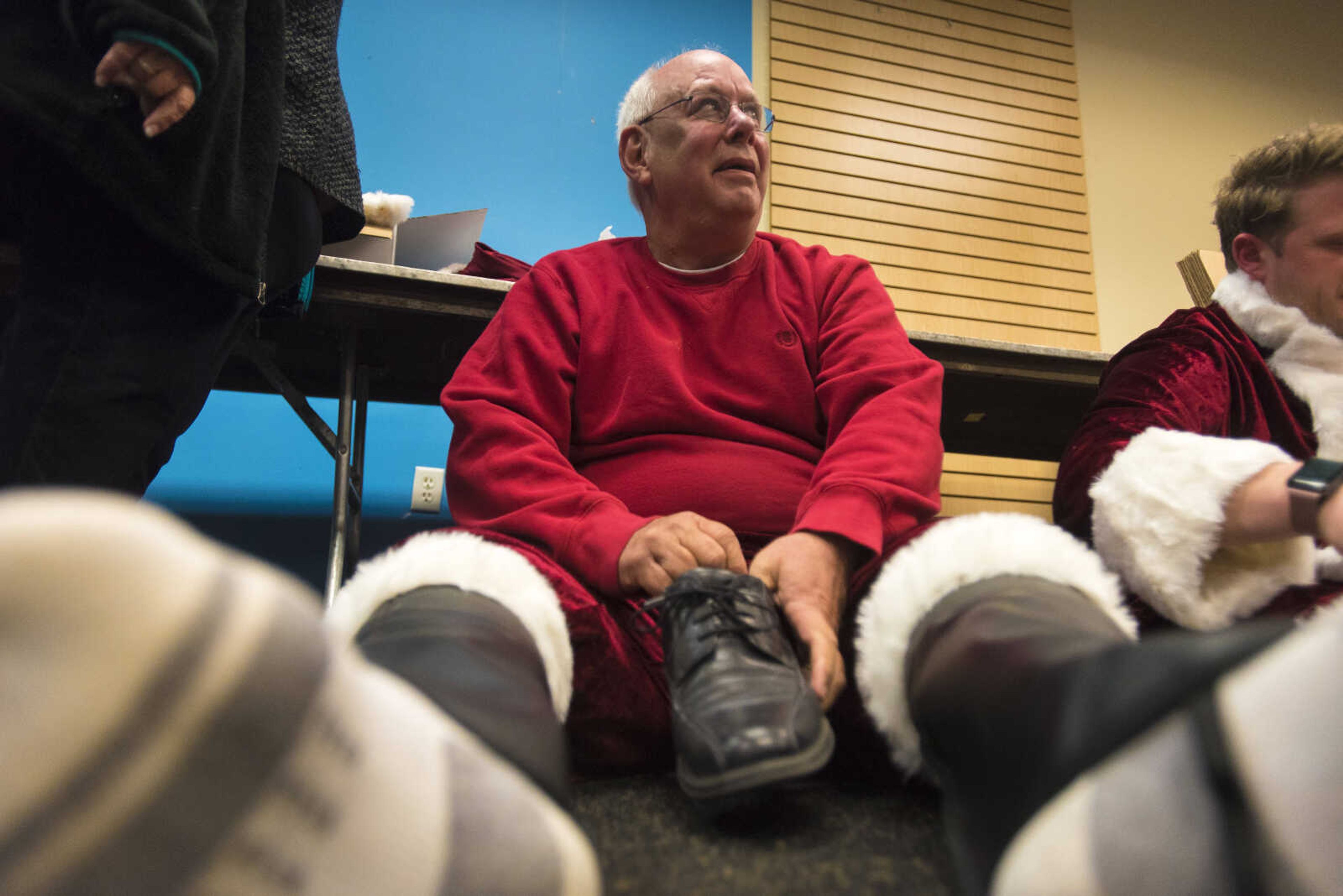 Doug Hunt puts on his boots during the Jaycee Toybox delivery on Thursday, Dec. 21, 2017, in Cape Girardeau.