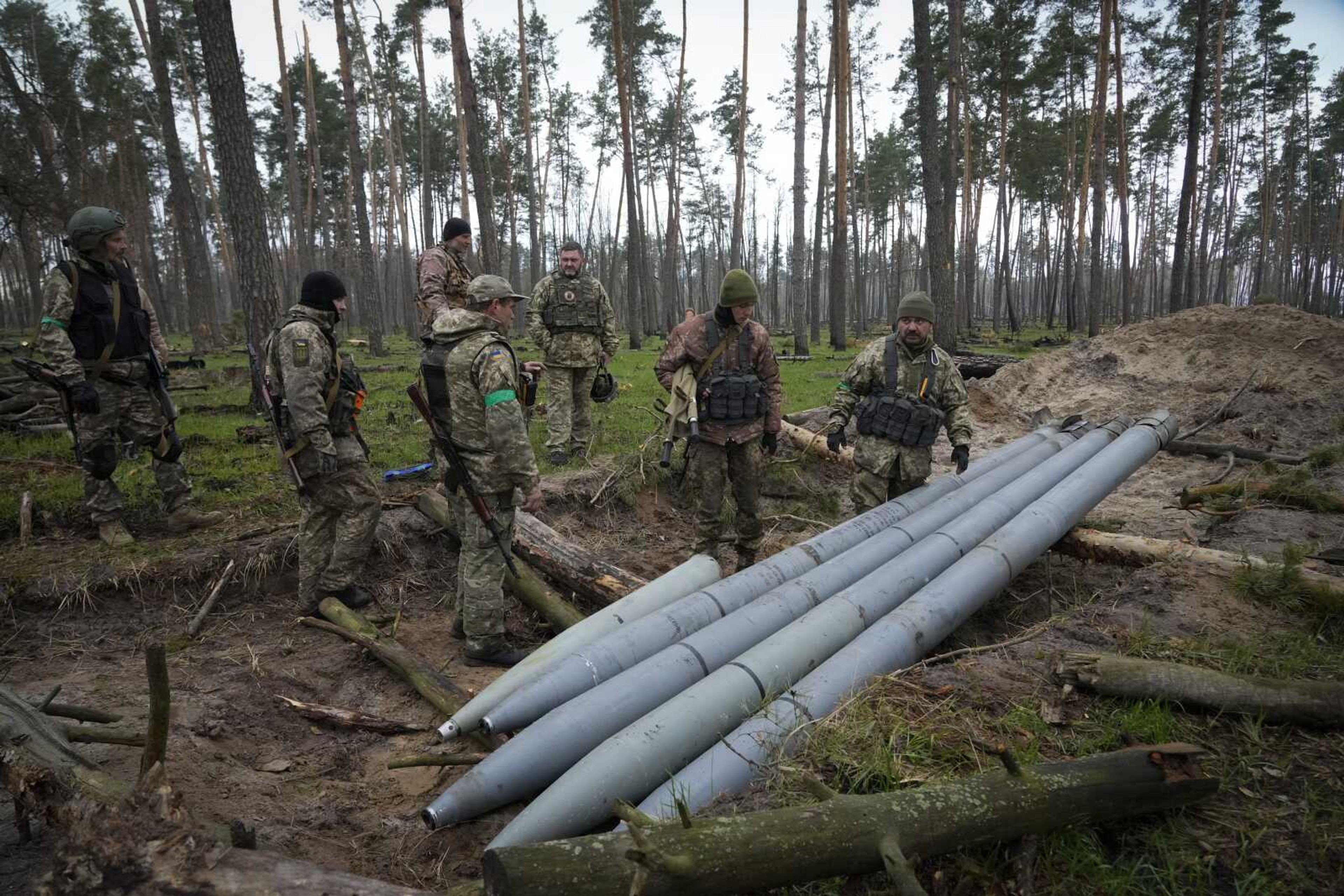 On Thursday, Ukrainian soldiers examine Russian multiple missiles abandoned by Russian troops, in the village of Berezivka, Ukraine.