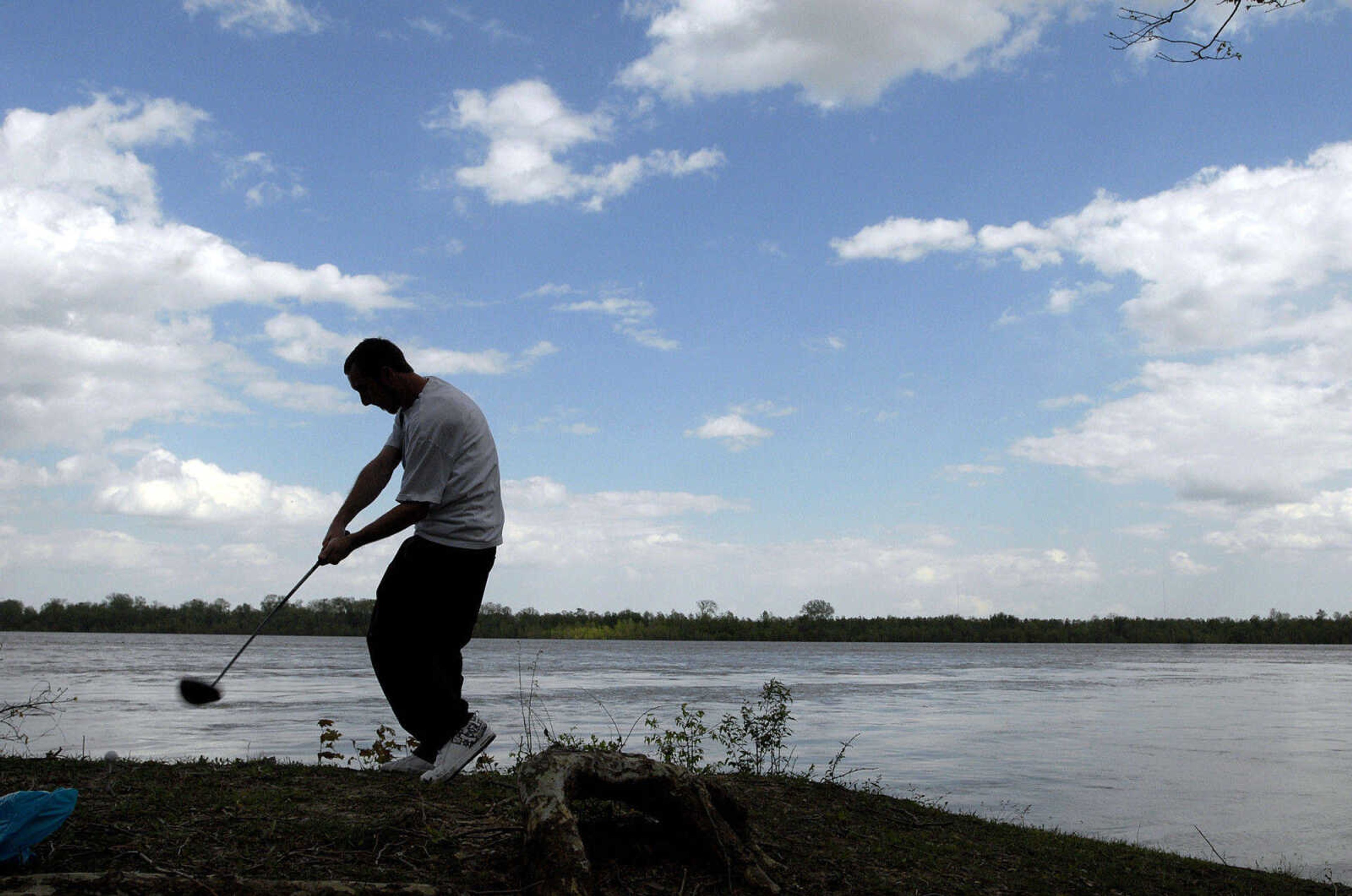 LAURA SIMON~lsimon@semissourian.com
Jason Gipson hits golf balls into the flooded Mississippi River from the area below Cape Rock in Cape Girardeau Thursday, April 28, 2011.