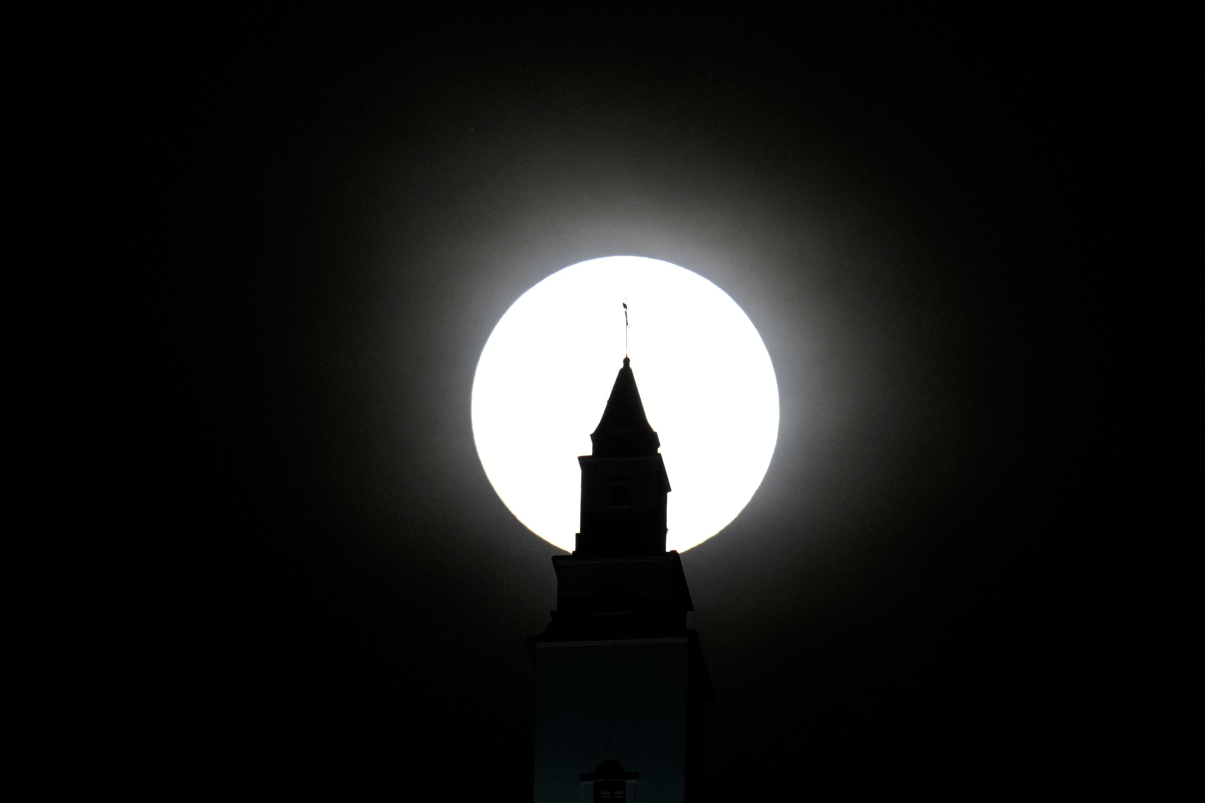 The supermoon looms over a basilica in Bogota, Colombia, Wednesday, Oct. 16, 2024. (AP Photo/Fernando Vergara)