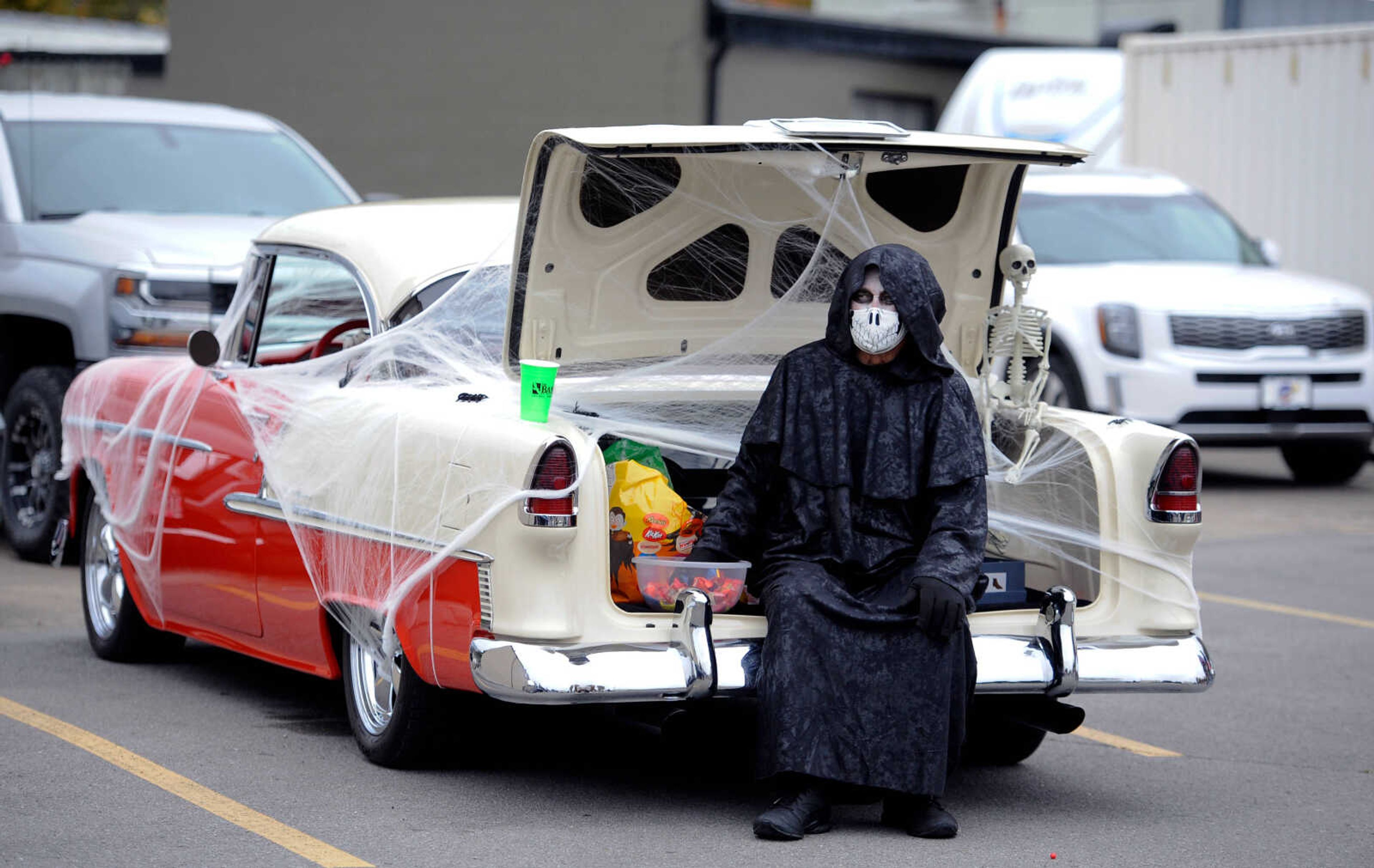 Danny Essner, dressed as a Grim Reaper, is seen sitting in the trunk of his 1955 Chevy with a bowl of candy while he waits for trunk-or-treaters at the Monster Mash Car Bash. Essner was awarded the Spookiest VehicleВќ award at the event on Sunday, Oct. 25, 2020, held in the parking lot at 35 S. Spanish St.&nbsp;