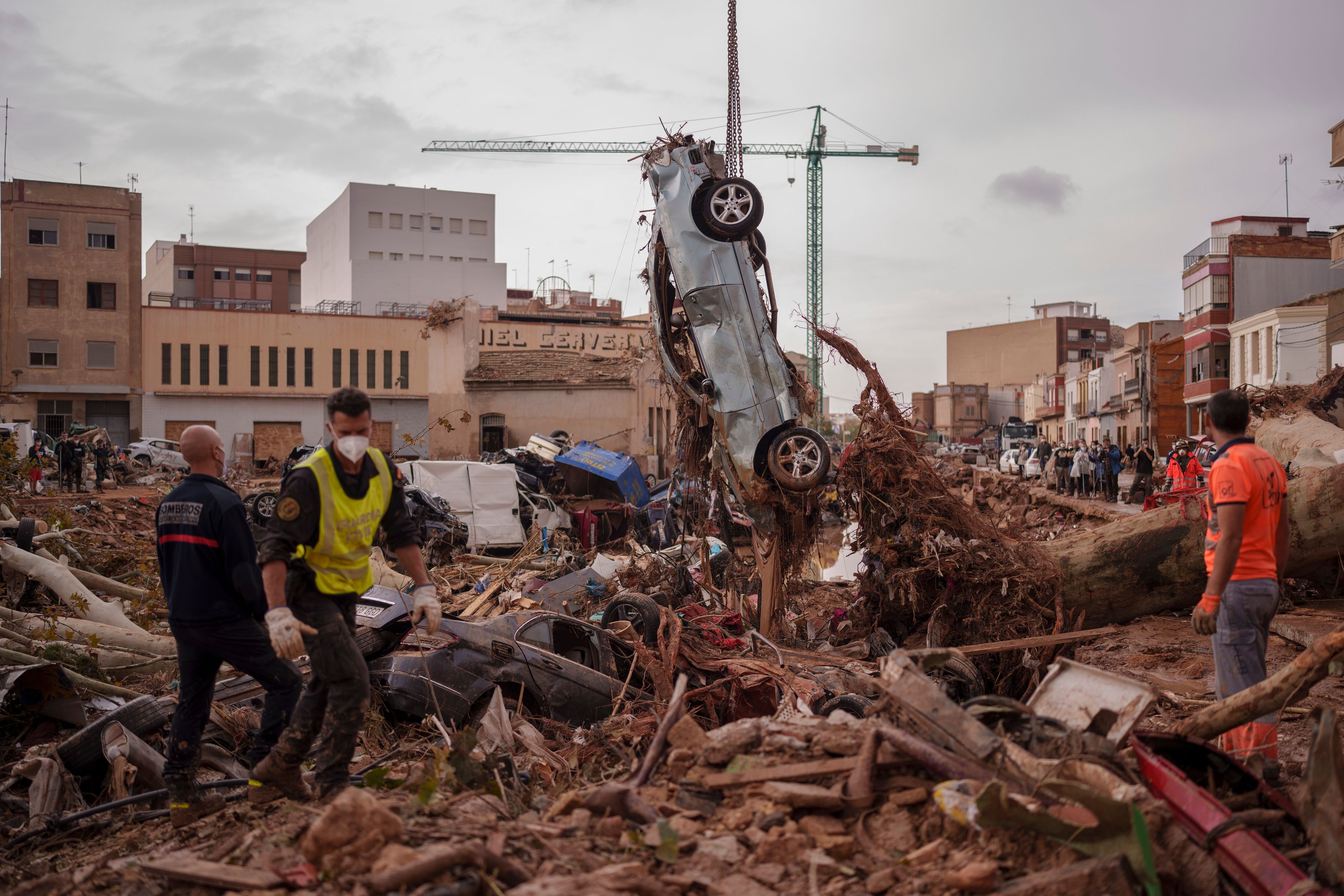 Emergency services remove cars in an area affected by floods in Catarroja, Spain, on Sunday, Nov. 3, 2024. (AP Photo/Manu Fernandez)