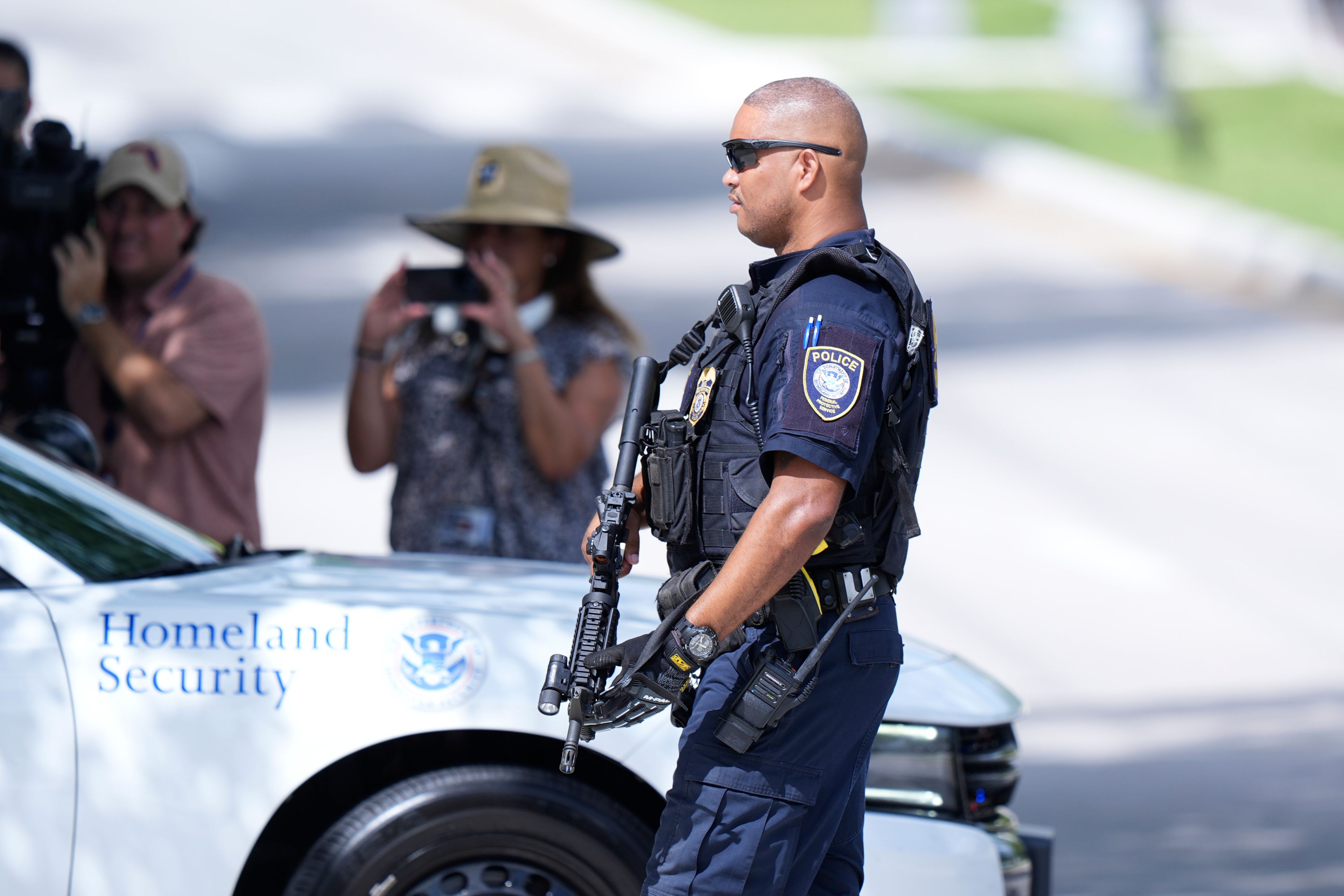 A Department of Homeland Security officer blocks traffic as a prisoner transport van prepares to leave the Paul G. Rogers Federal Building and U.S. Courthouse, where a man suspected in an apparent assassination attempt targeting former President Donald Trump, was charged with federal gun crimes, Monday, Sept. 16, 2024, in West Palm Beach, Fla. (AP Photo/Wilfredo Lee)