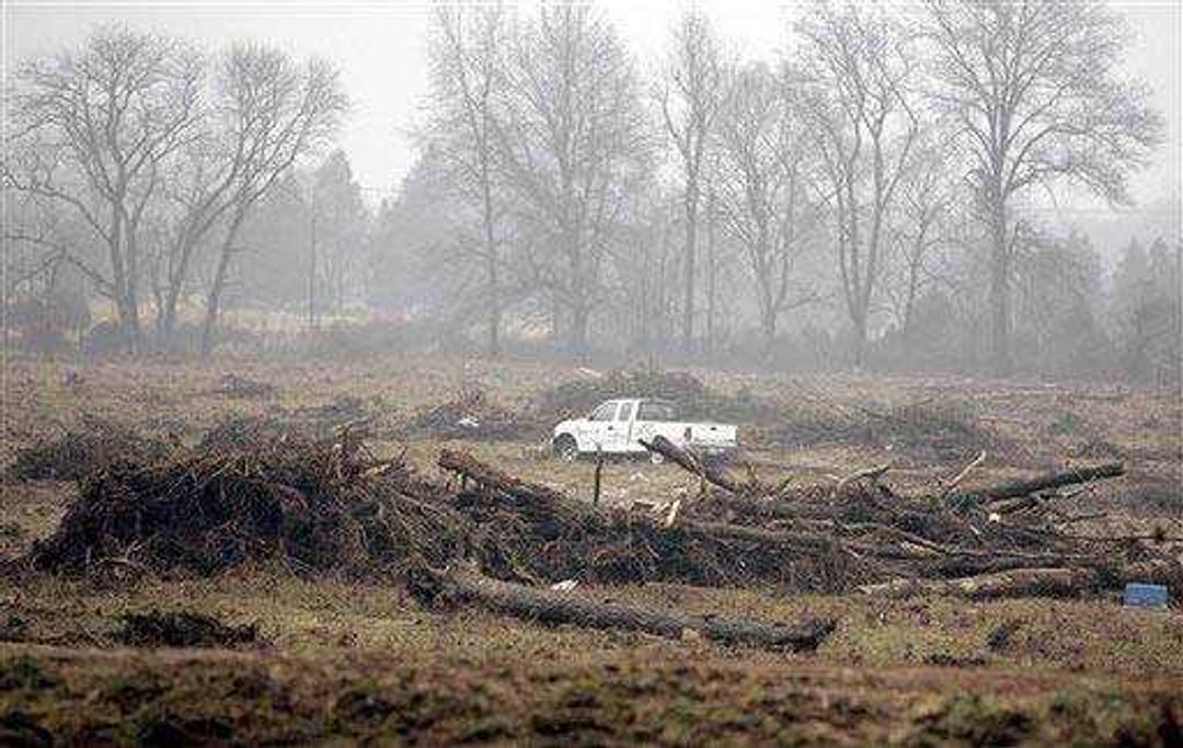 A truck caught in the floodwaters from the breach sits in the resulting debris. (Associated Press)